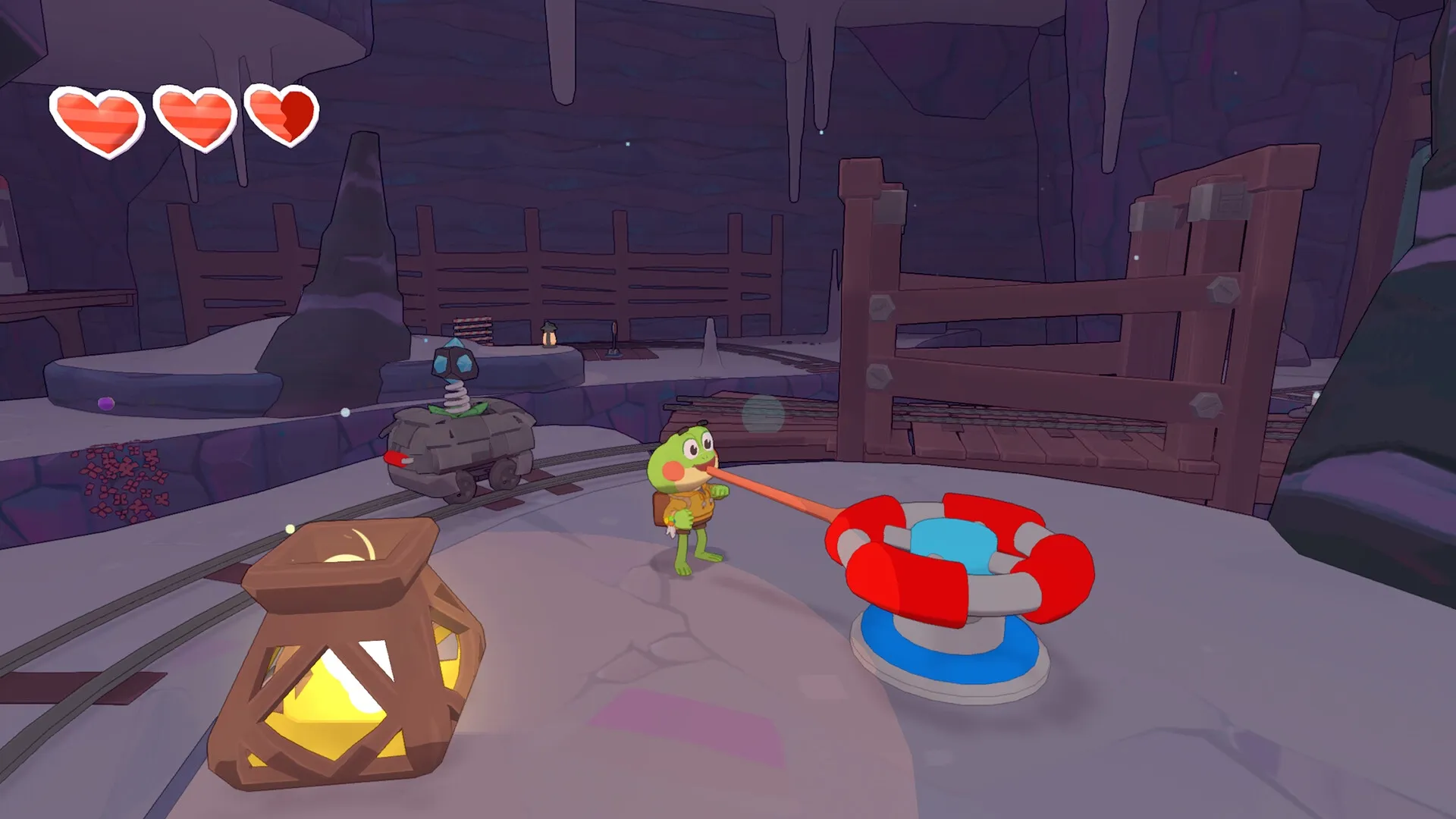 Big Hops: Frog character uses tongue to interact with a device in a cave with heart icons visible