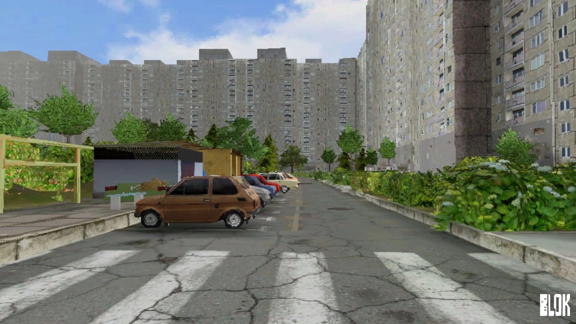 BLOK: Empty apartment block courtyard with parked cars and cracked crosswalk under blue sky.
