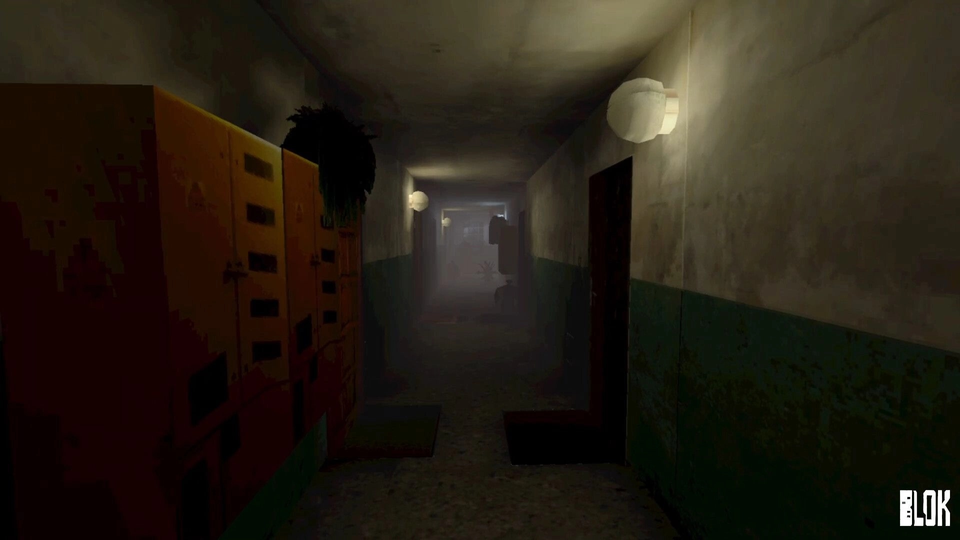 BLOK: Walking down a dim, foggy apartment corridor with lockers, doors, and wall lamps ahead.