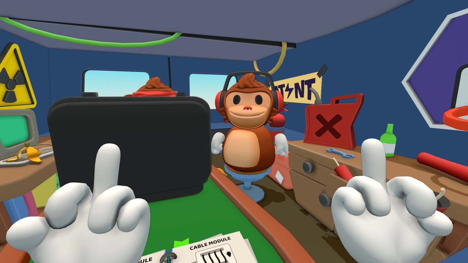 BOMBANANA!: First-person view of gloved hands facing headset monkey in cluttered van workshop.