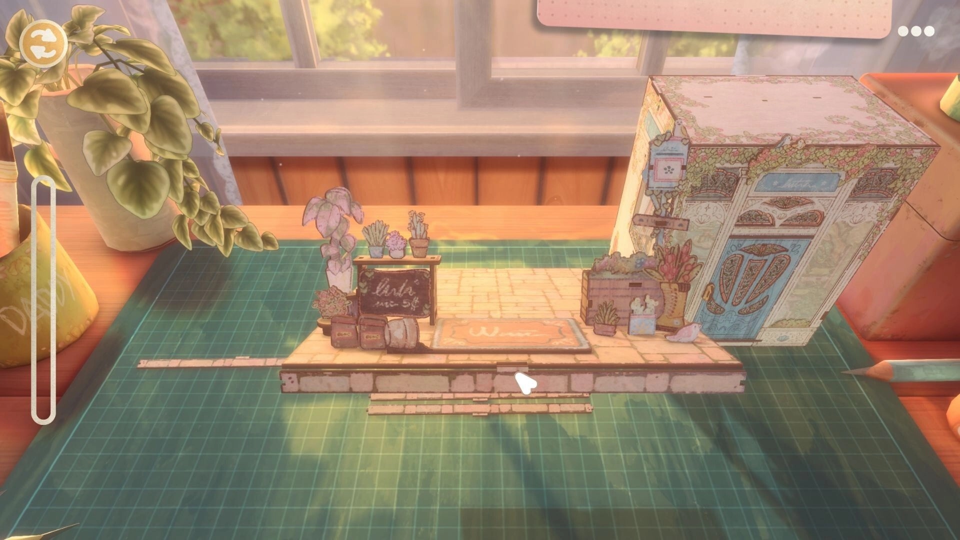 Book Nook: Assembling a tiny storefront diorama on a cutting mat, with rotate icon and cursor visible.