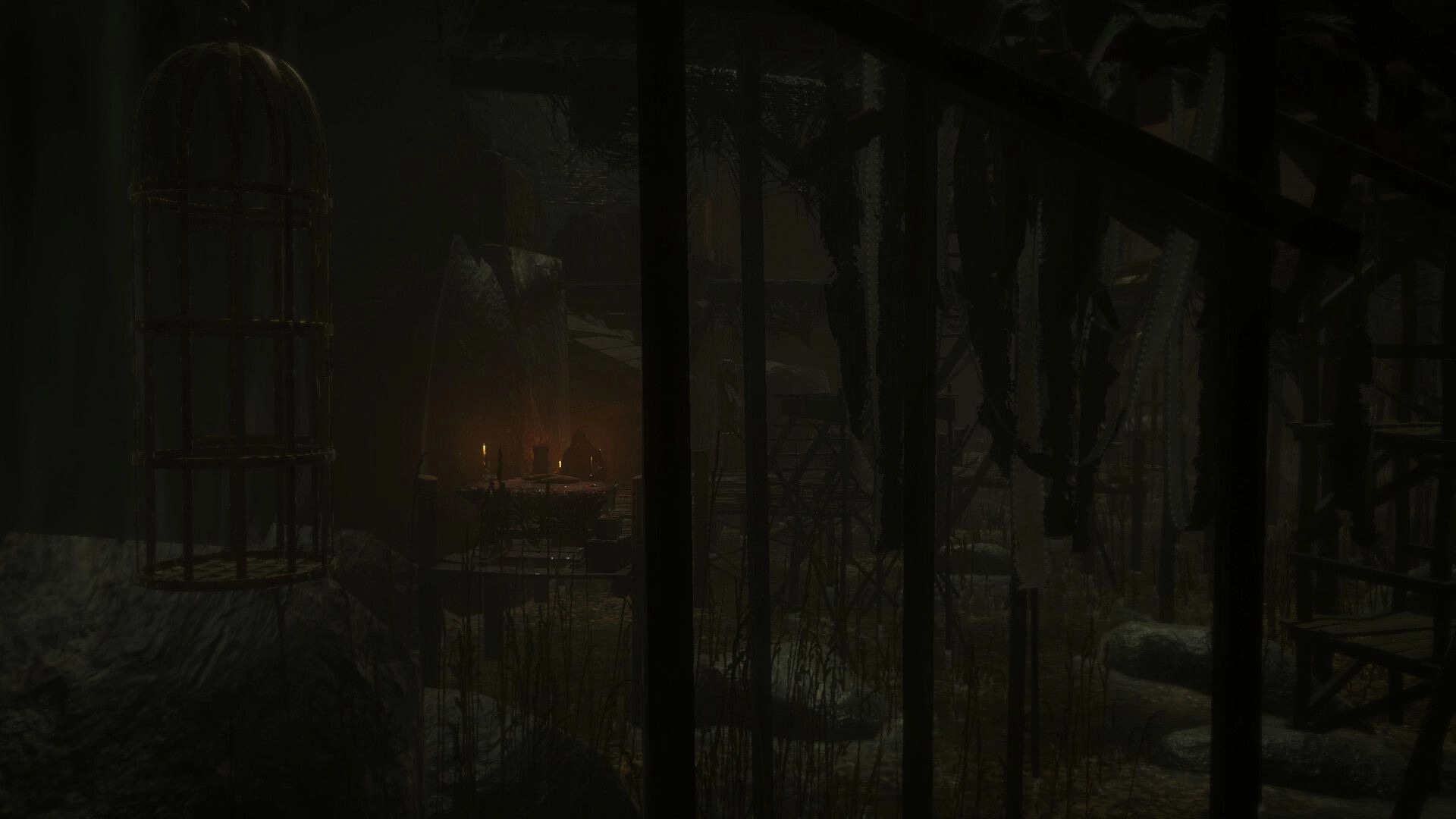 BRAMBLEFORT: View through iron bars toward candlelit huts and swampy ruins in dense night fog.