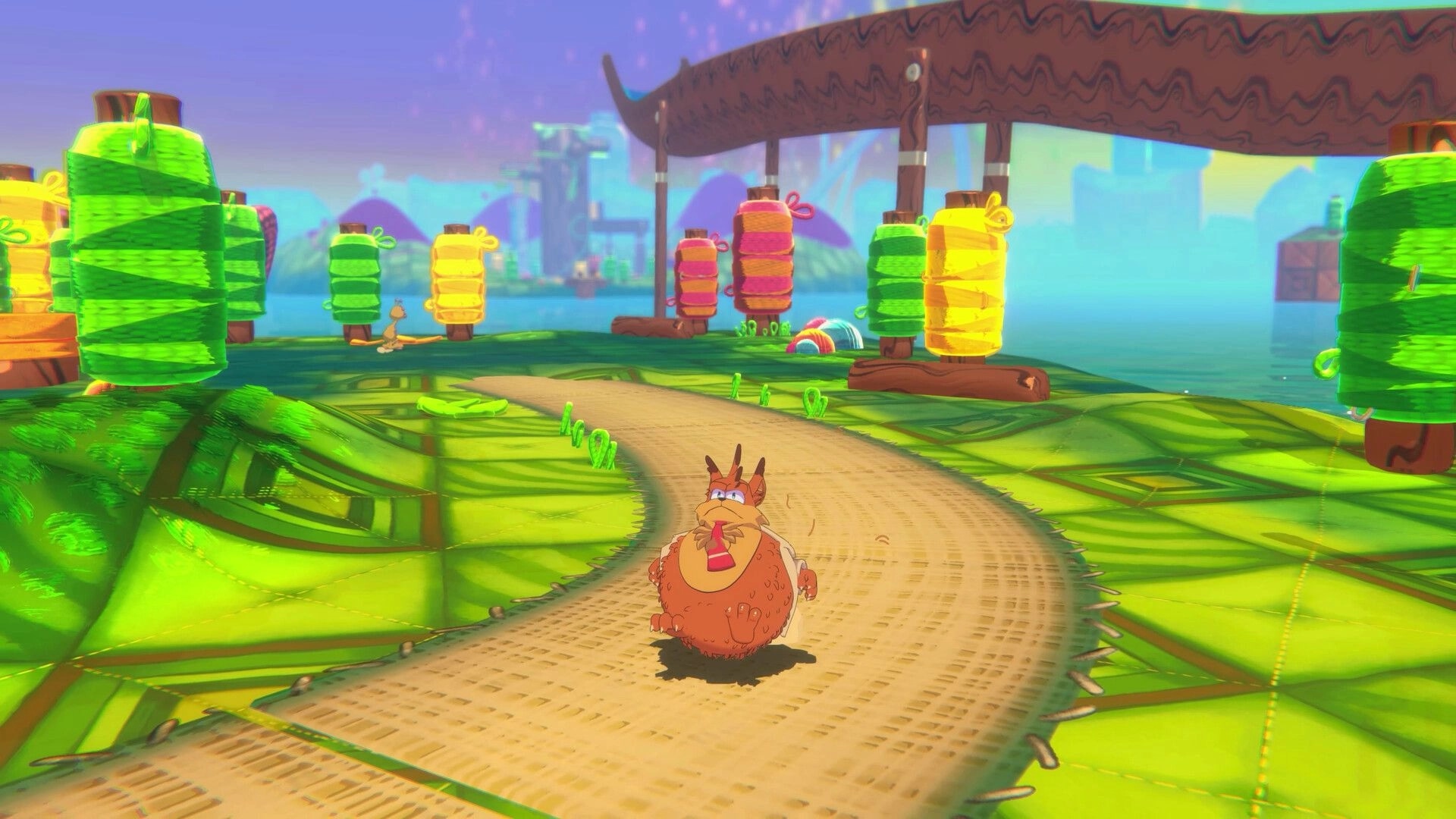 Bubsy 4D: Bubsy running on a yarn-themed path surrounded by colorful, giant spools on an alien planet.