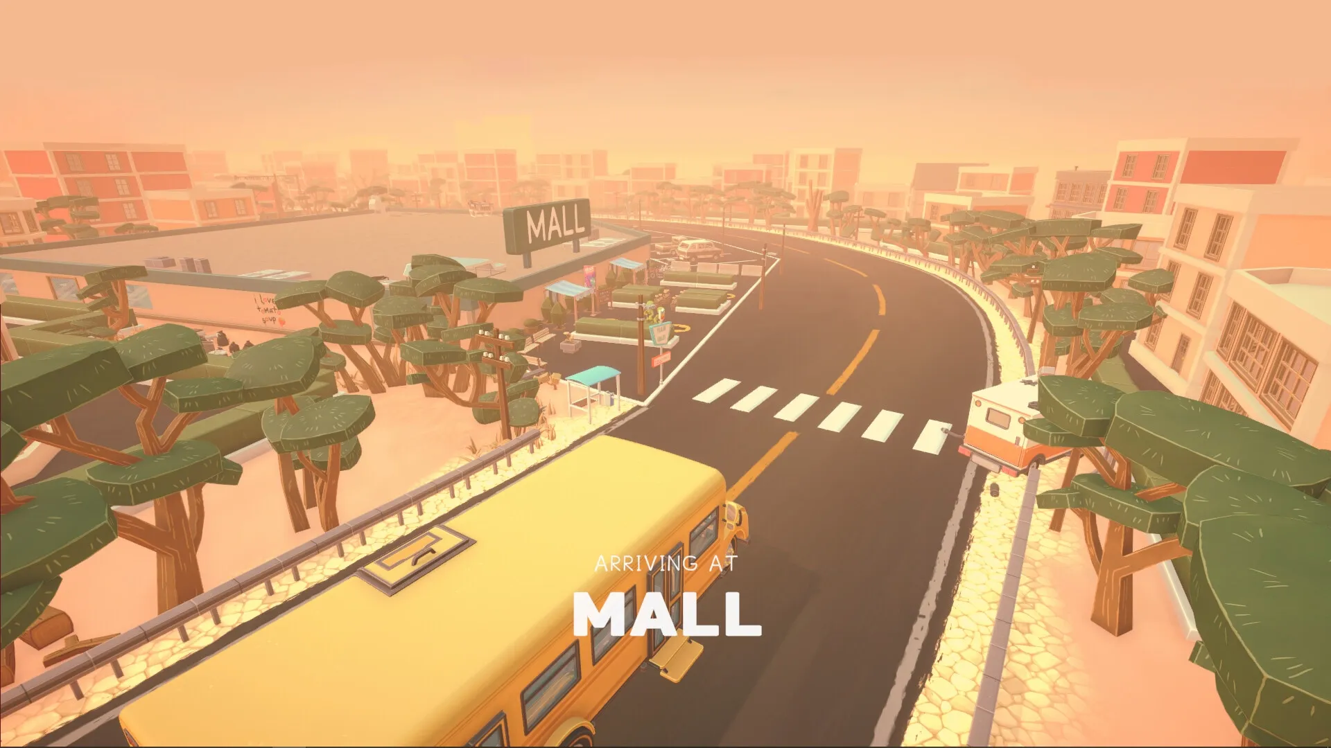 BUS: Yellow bus approaching a mall surrounded by trees and buildings on a sunny island road.