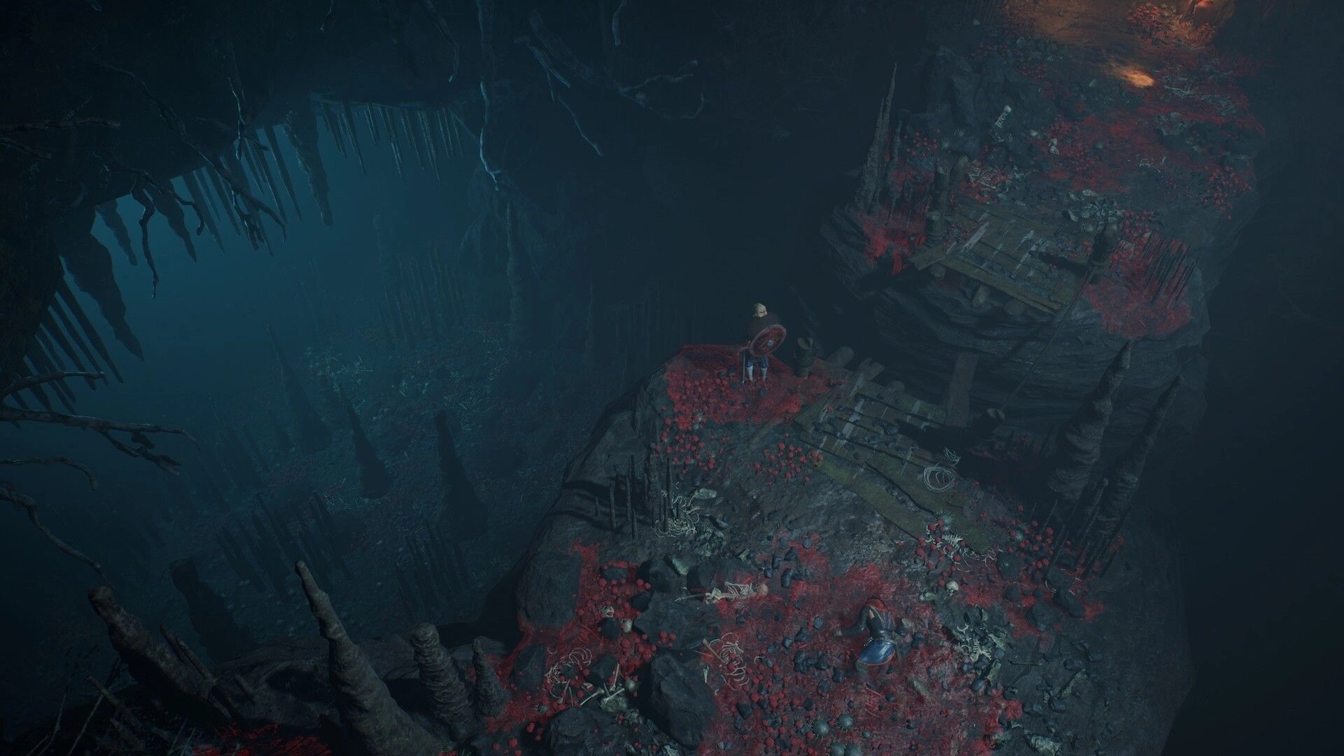 Bylina: Hero stands on a cliff by a wooden bridge above a misty cavern with red foliage.