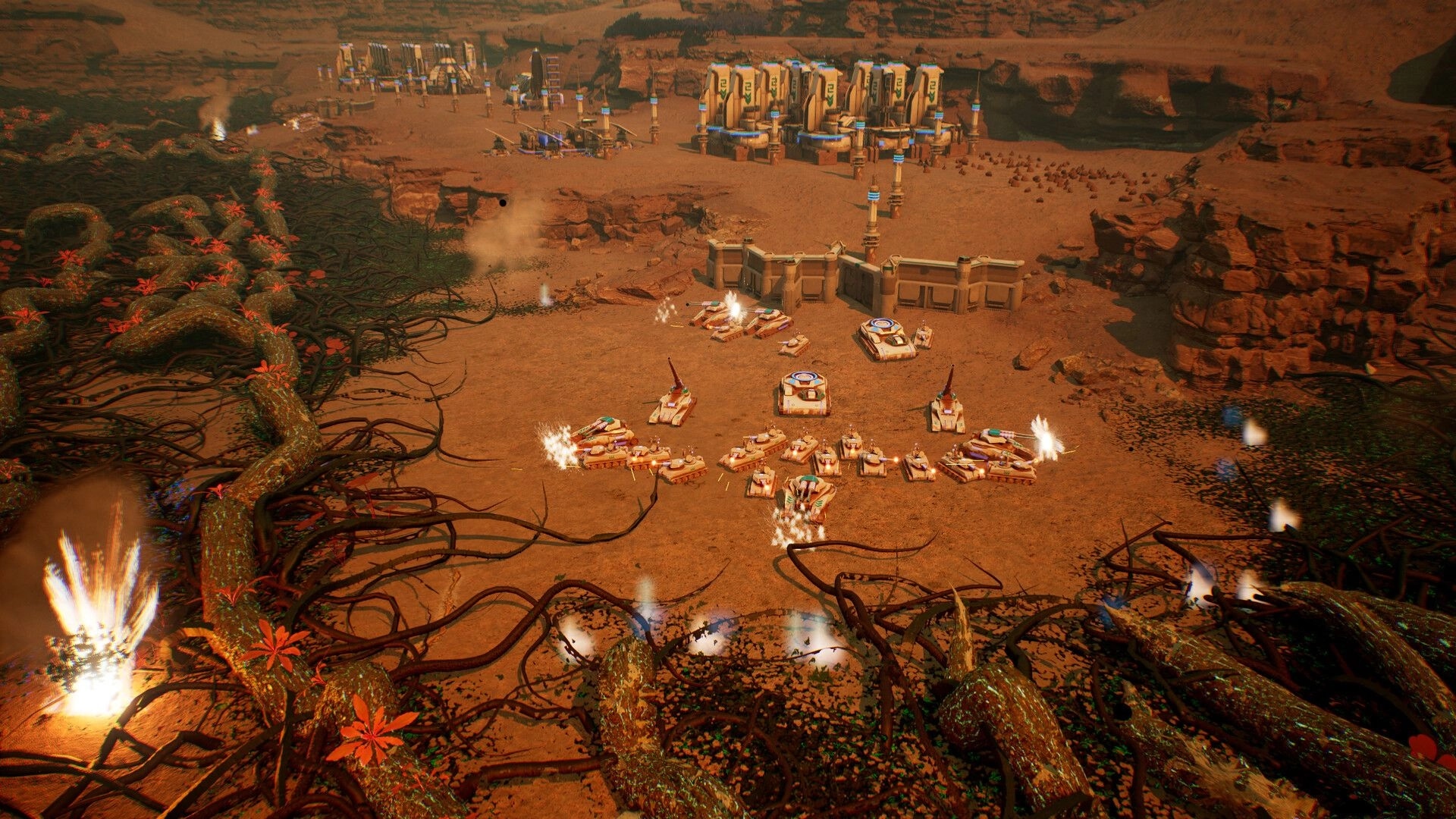 Calyx: Tanks defending base against alien roots in desert canyon environment with resource buildings nearby.