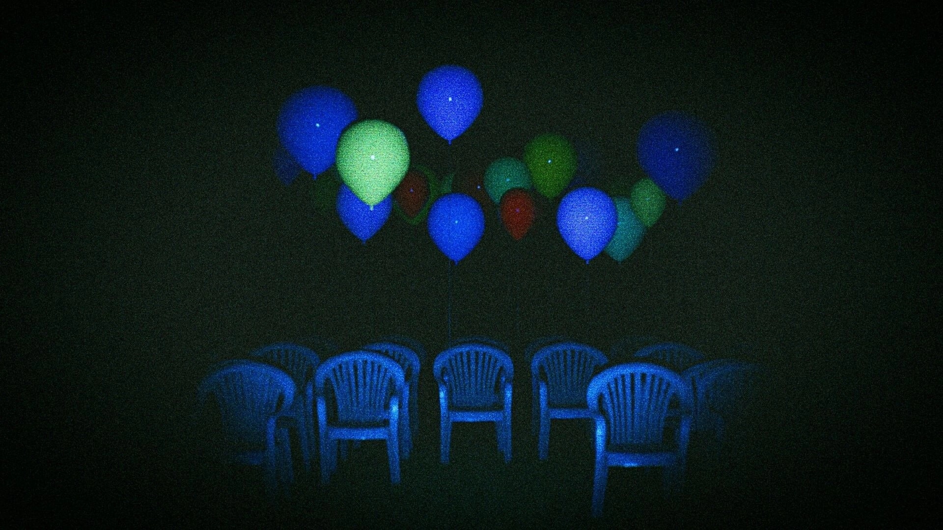 CAPTURED 2: Cluster of glowing balloons above empty plastic chairs in a dark, grainy room.