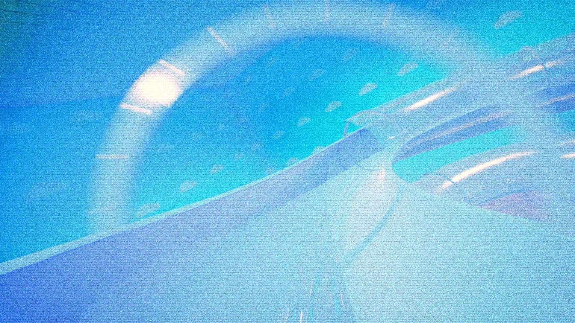 CAPTURED 2: Blinding blue glare and warped hallway view with heavy film grain in a curved corridor.