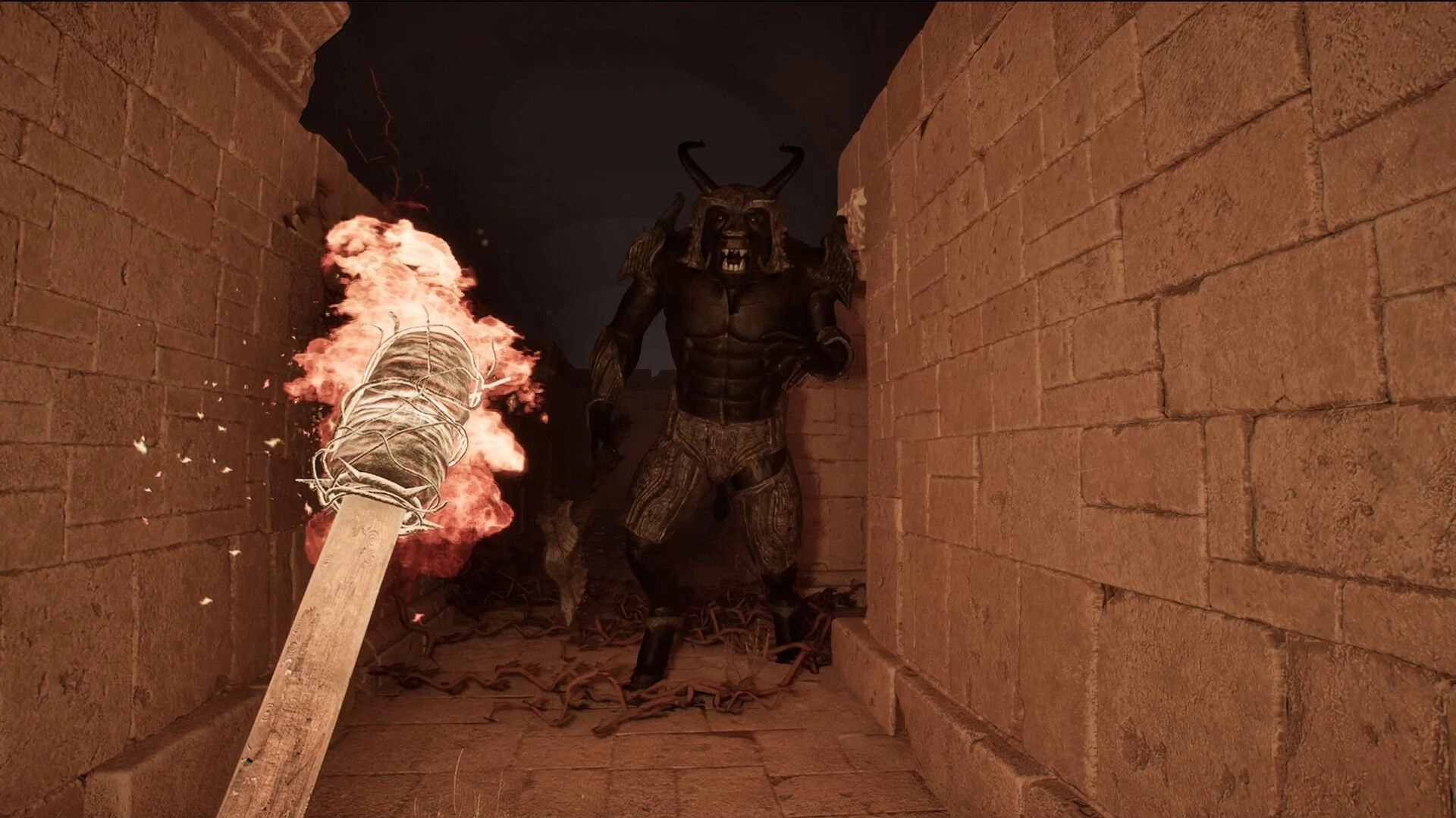 Carcerem: Player holding a flaming torch faces a horned monster in a narrow stone labyrinth corridor.