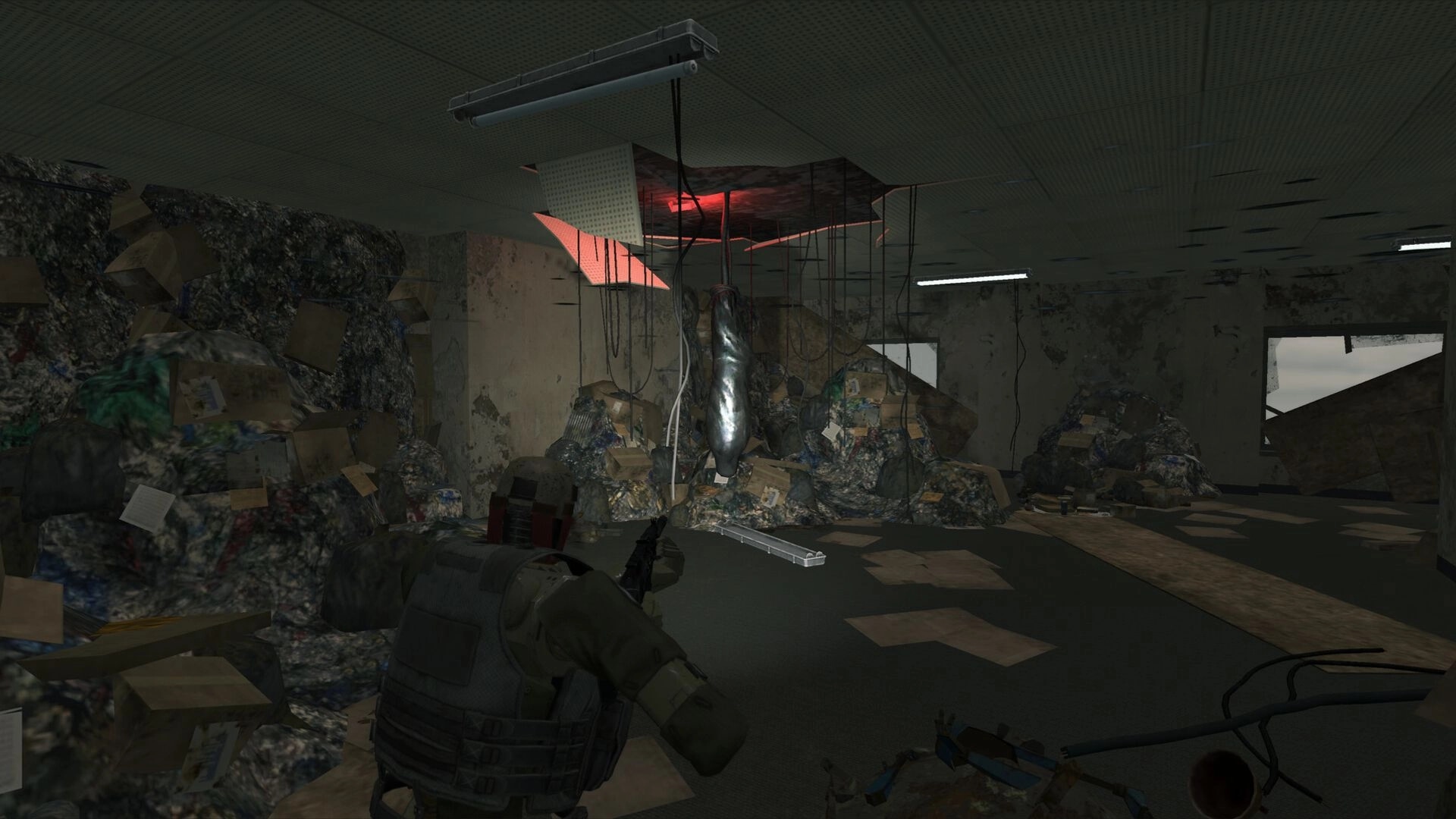 Cargo Hunters: Third-person soldier aiming rifle in a ruined office filled with trash and hanging cables.