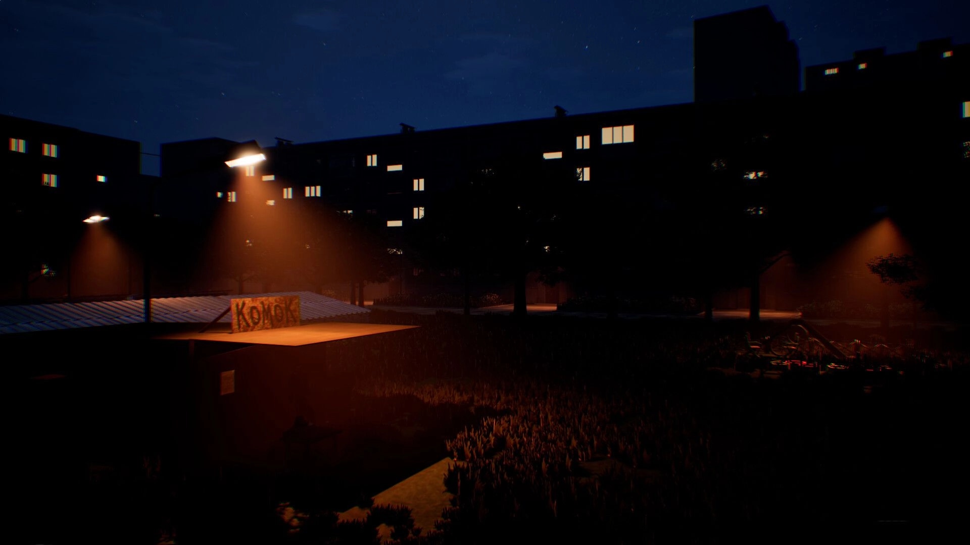 Change: Night street view of apartment blocks and a lit kiosk roof sign under orange streetlights.