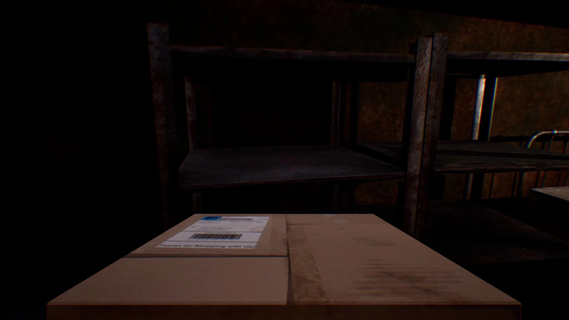 Change: First-person view of a sealed cardboard box on a table beside empty metal shelves in a dark stall.