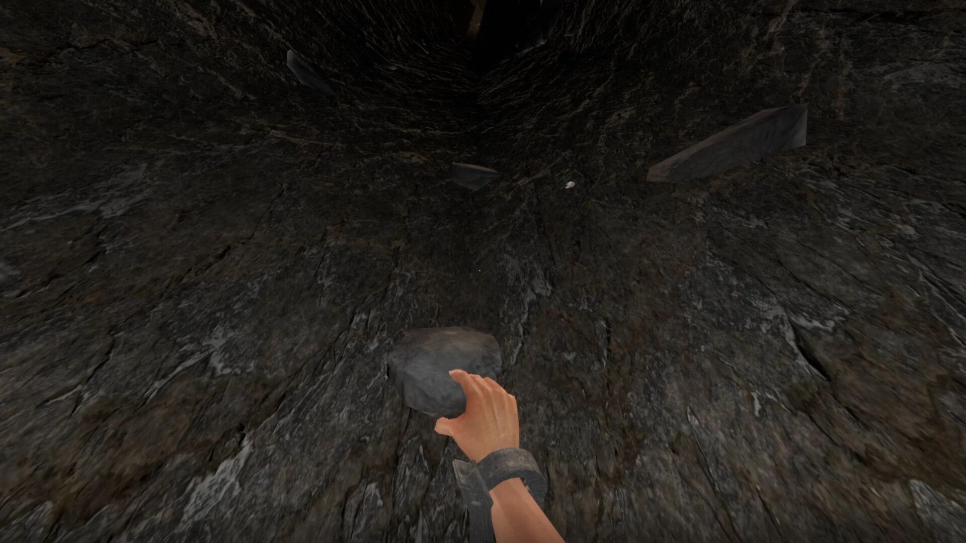 Cobble Climber: First-person hand grabbing a stone hold on a steep dark cliff face with debris above.
