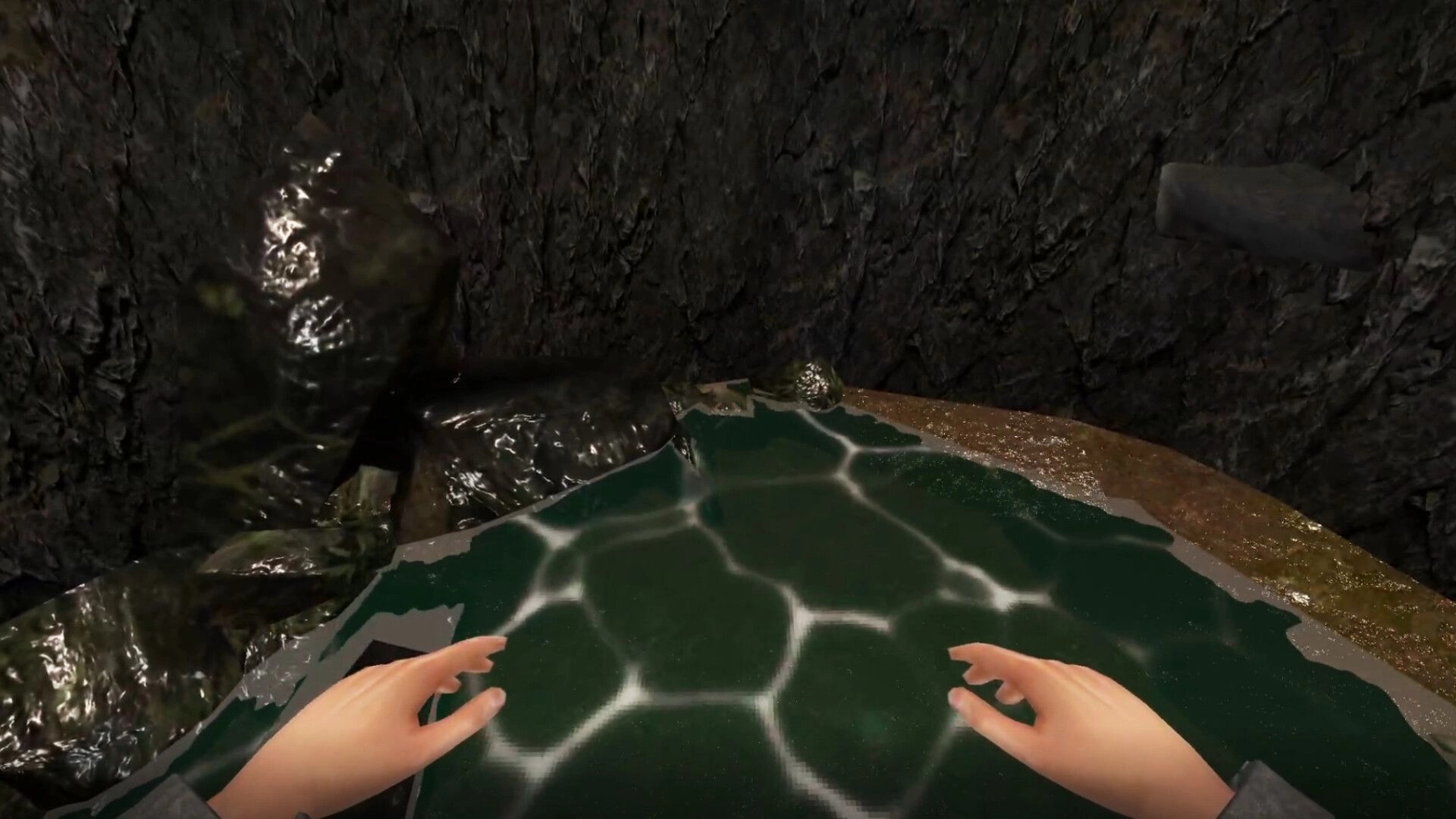 Cobble Climber: First-person hands on a slick green ledge above rippling water in a rocky cave.