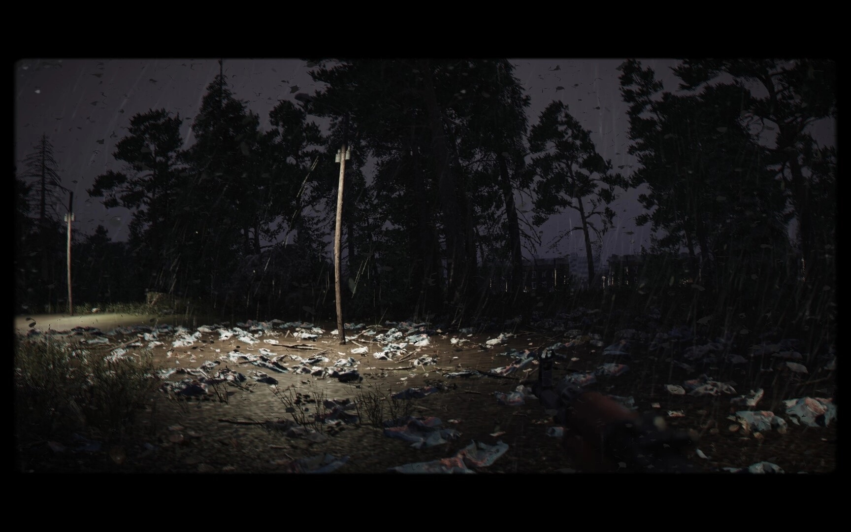 Cold Response: Rain lashes a debris-strewn road with leaning power pole beside a dark forest edge.