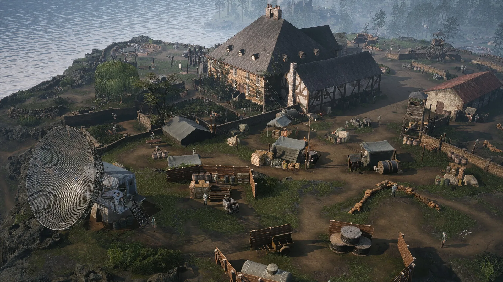 Commandos: Overhead view of a military base with tents, a radar dish, and soldiers near the coastline.