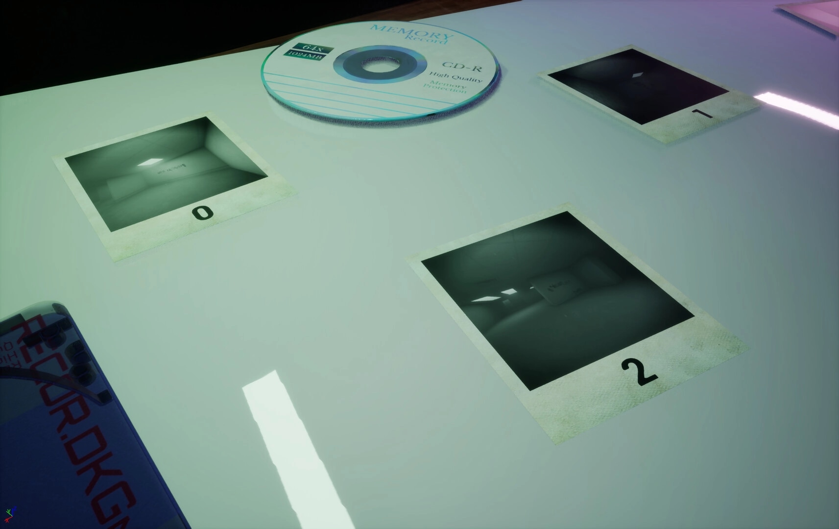 CoopRooms: Polaroid photos with numbered labels and a CD on a white table in a dimly lit room