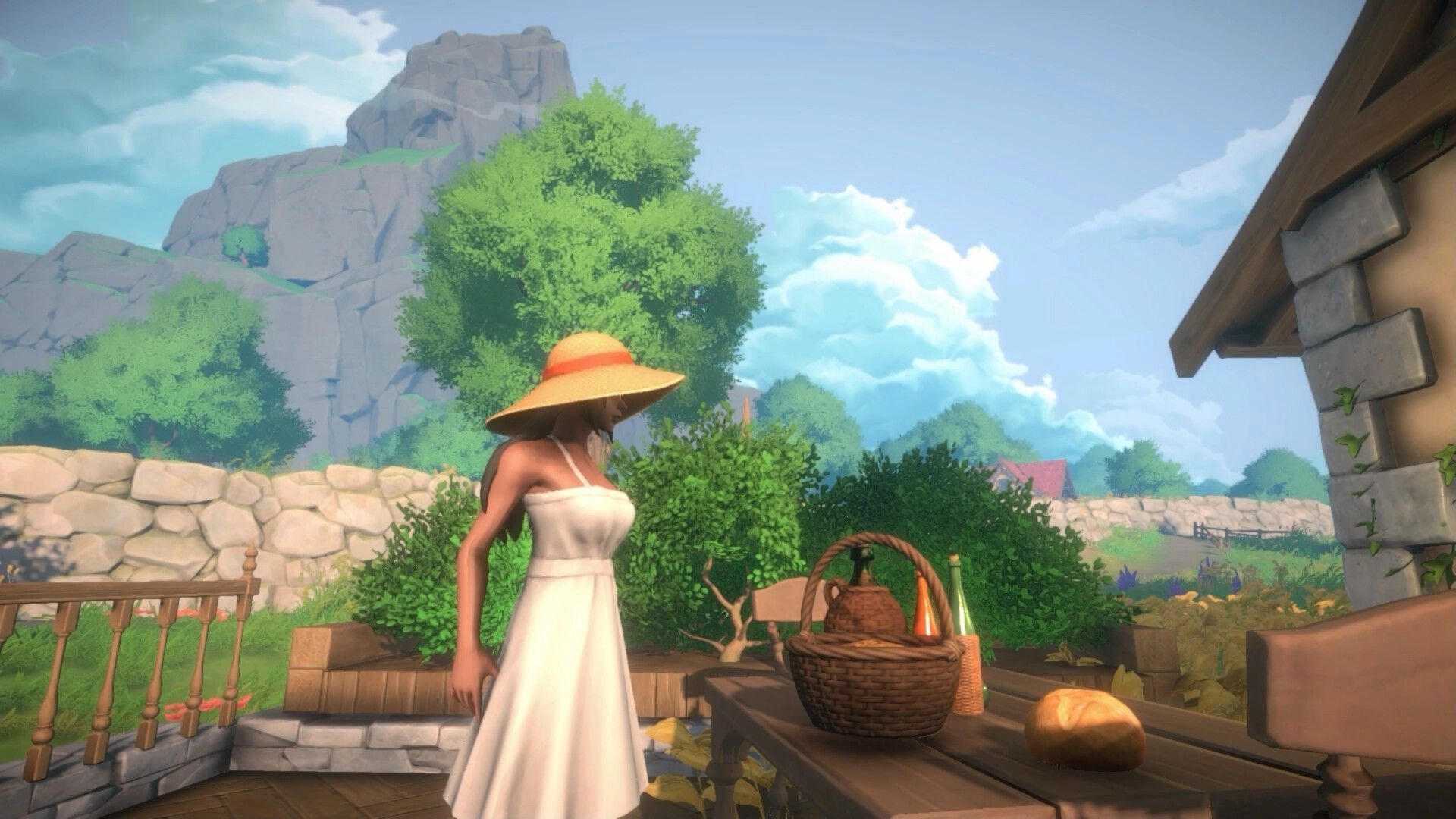 Cozy Builder: Woman in sunhat stands by picnic table on patio with mountains and stone wall beyond.