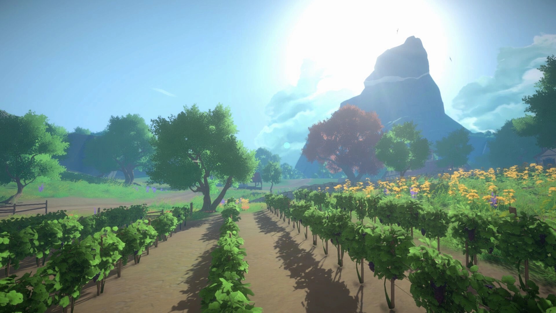 Cozy Builder: Sunlit vineyard rows along a dirt path with trees, wildflowers, and a mountain backdrop.