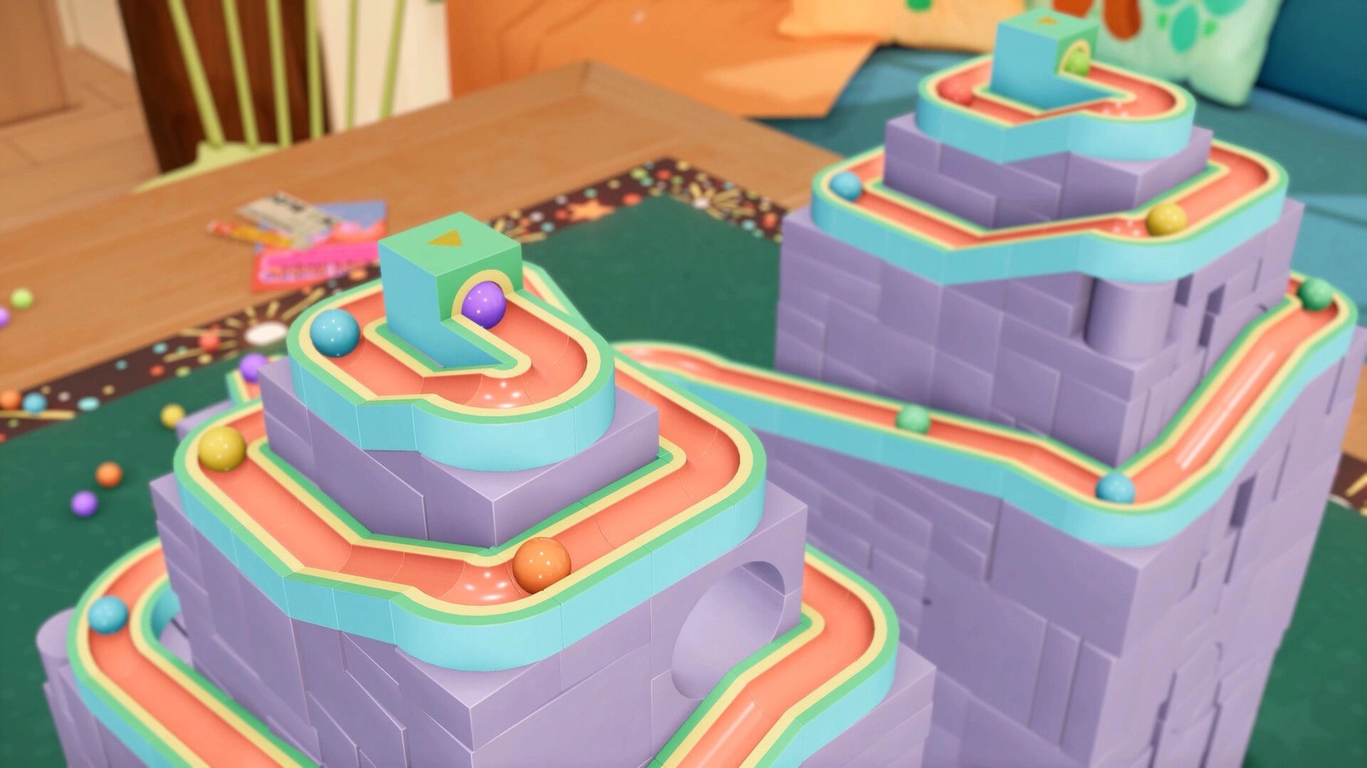 Cozy Marbles: Colorful marble tracks winding around purple block towers on a tabletop setting