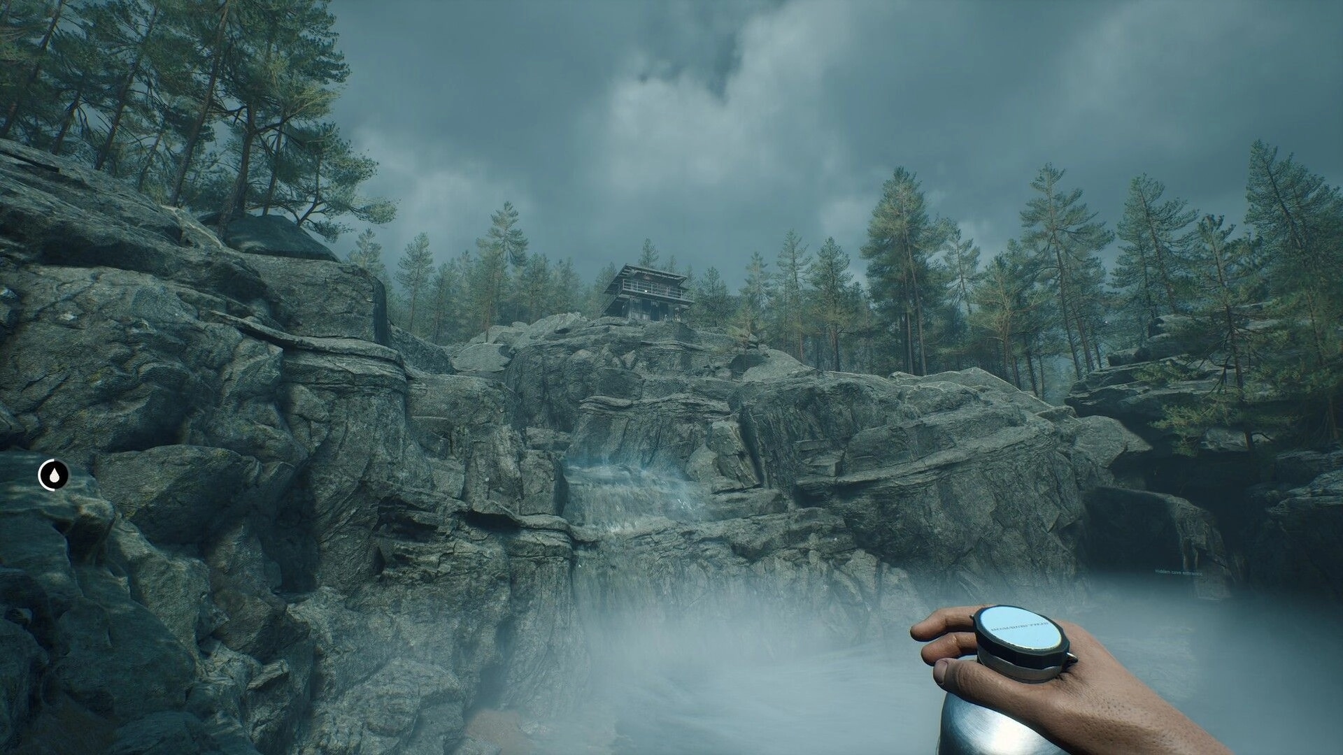 Deadhikers: Player holding compass in foggy rocky landscape with cabin atop cliff surrounded by trees