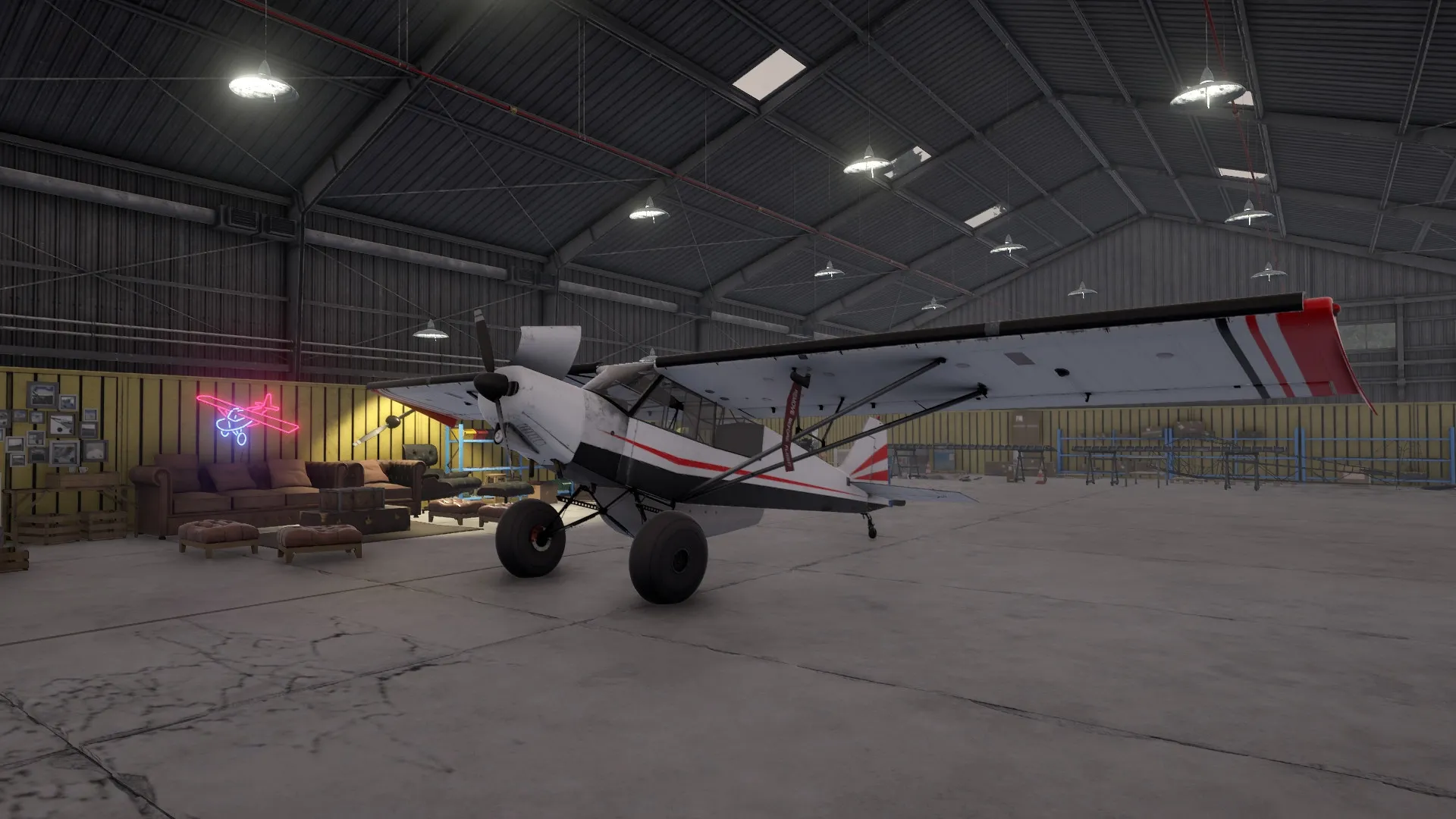 Deadstick: Small aircraft parked inside a spacious hangar with cozy seating area and neon plane sign