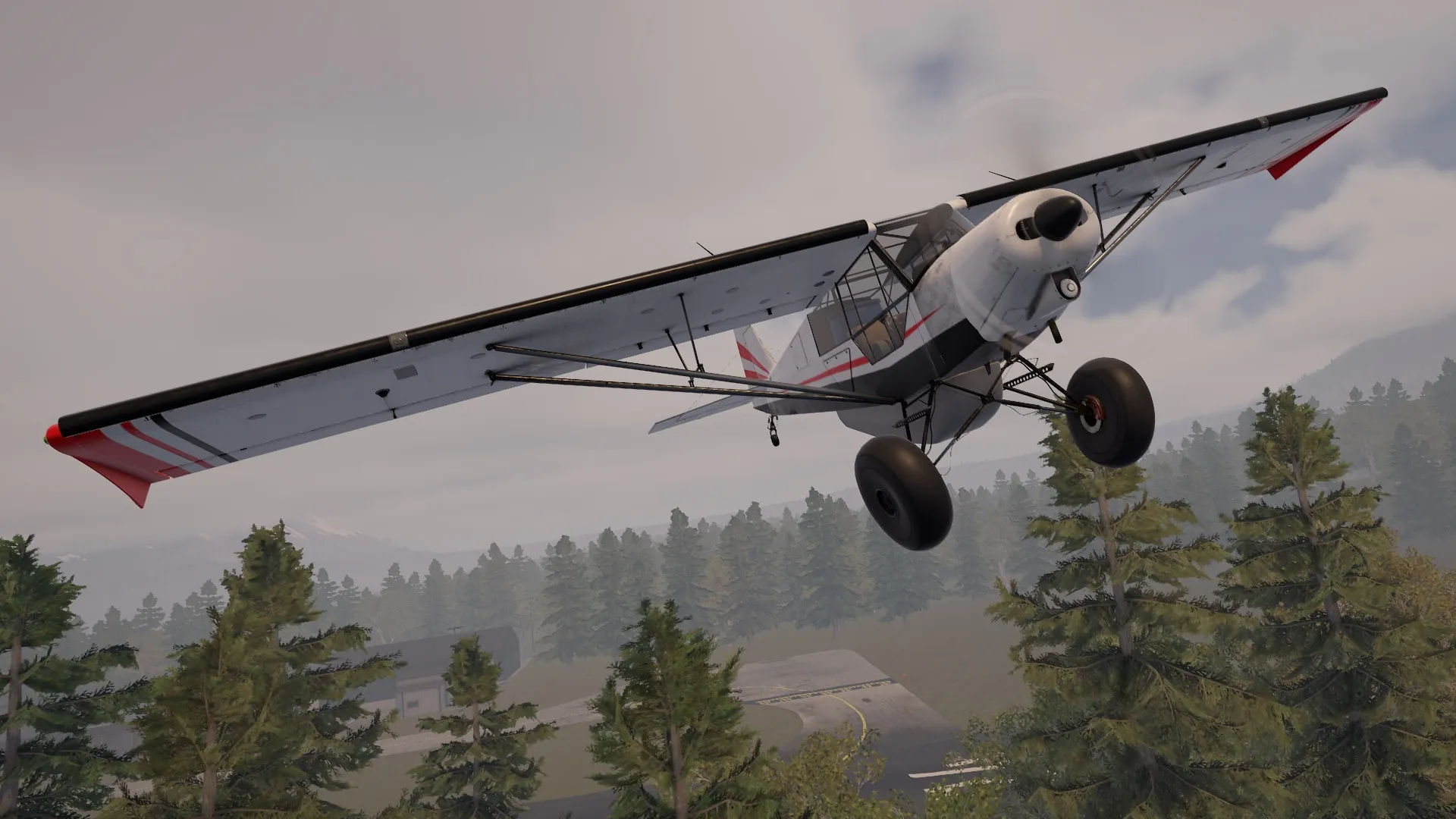Deadstick: Small aircraft flying low over a dense forest with a runway visible in the background
