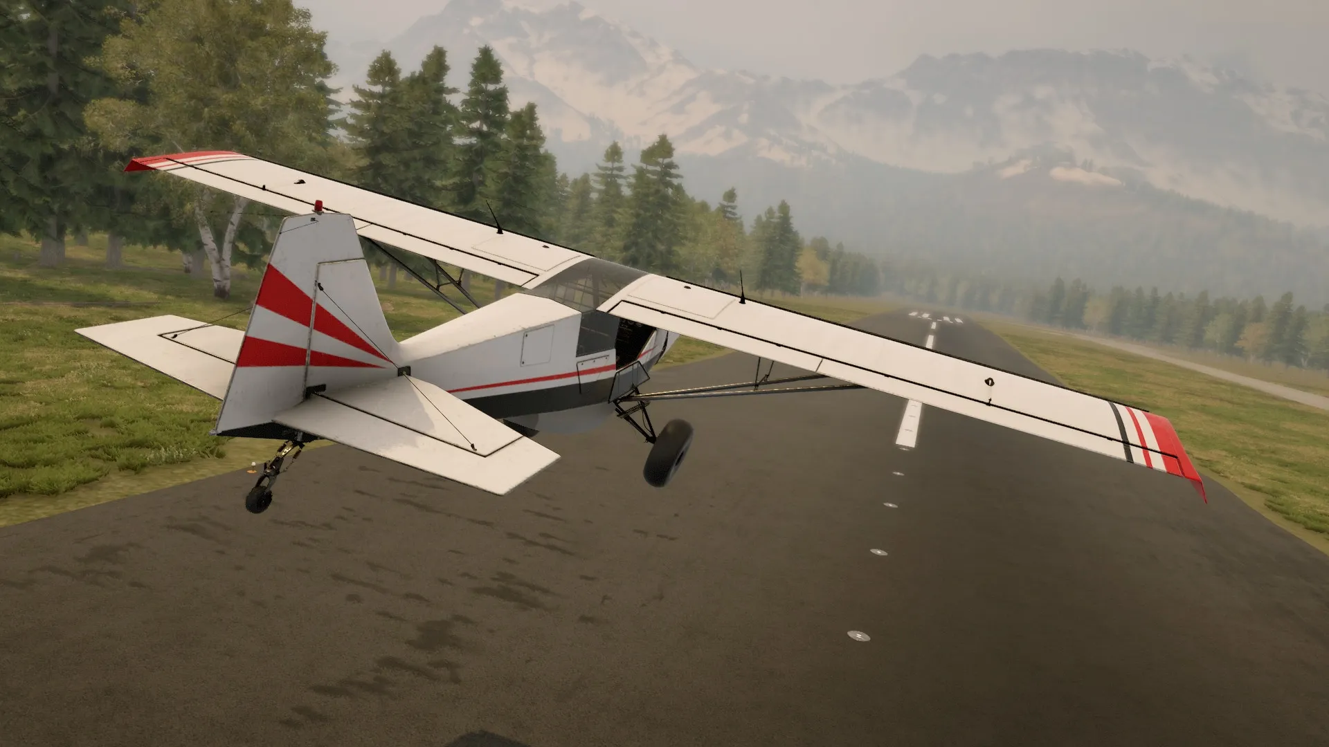 Deadstick: Aircraft taking off on a forest runway surrounded by trees and distant mountainous terrain