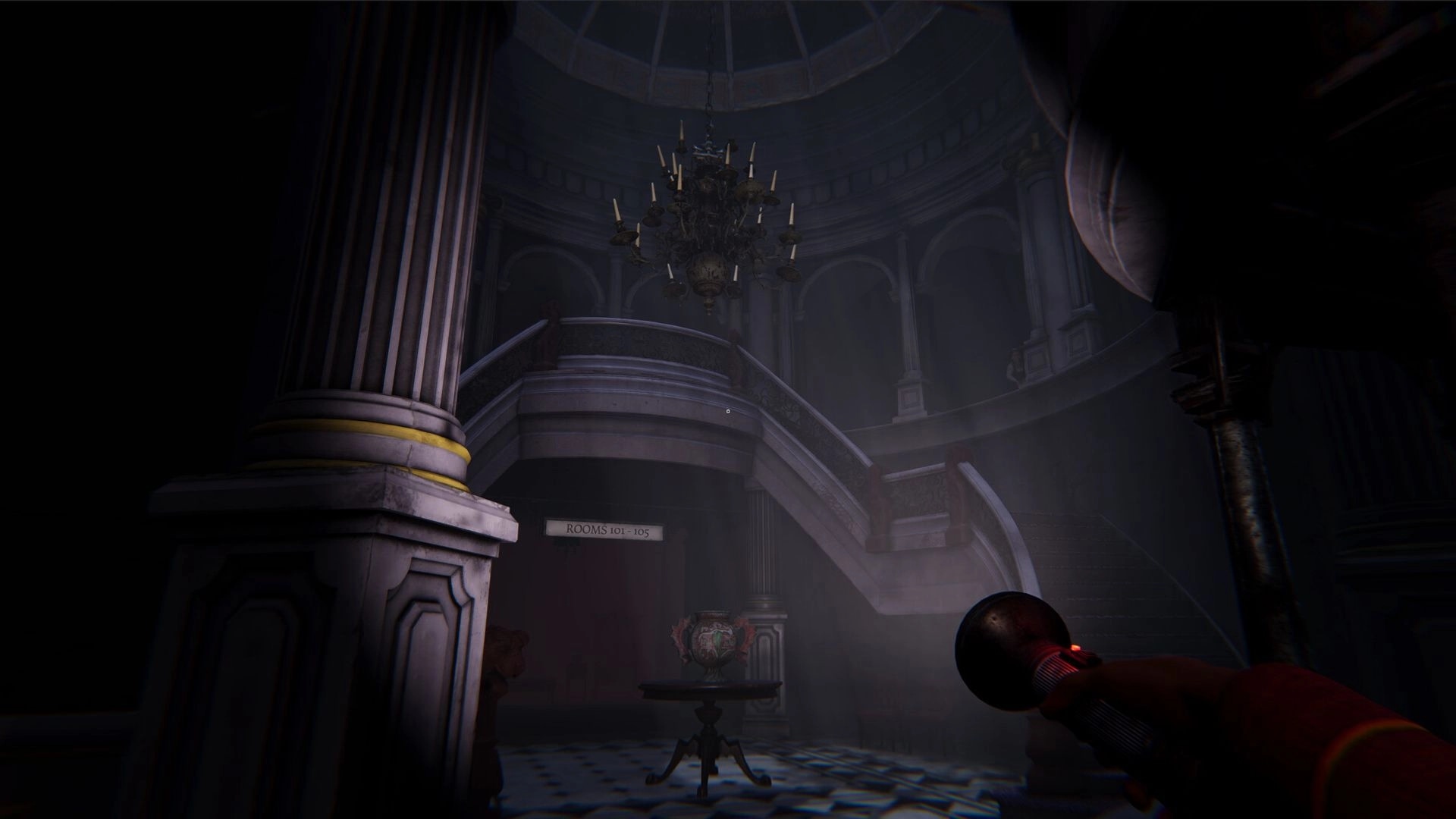 Deaduction: Player explores dimly lit hotel lobby with flashlight, grand staircase, and chandelier overhead.