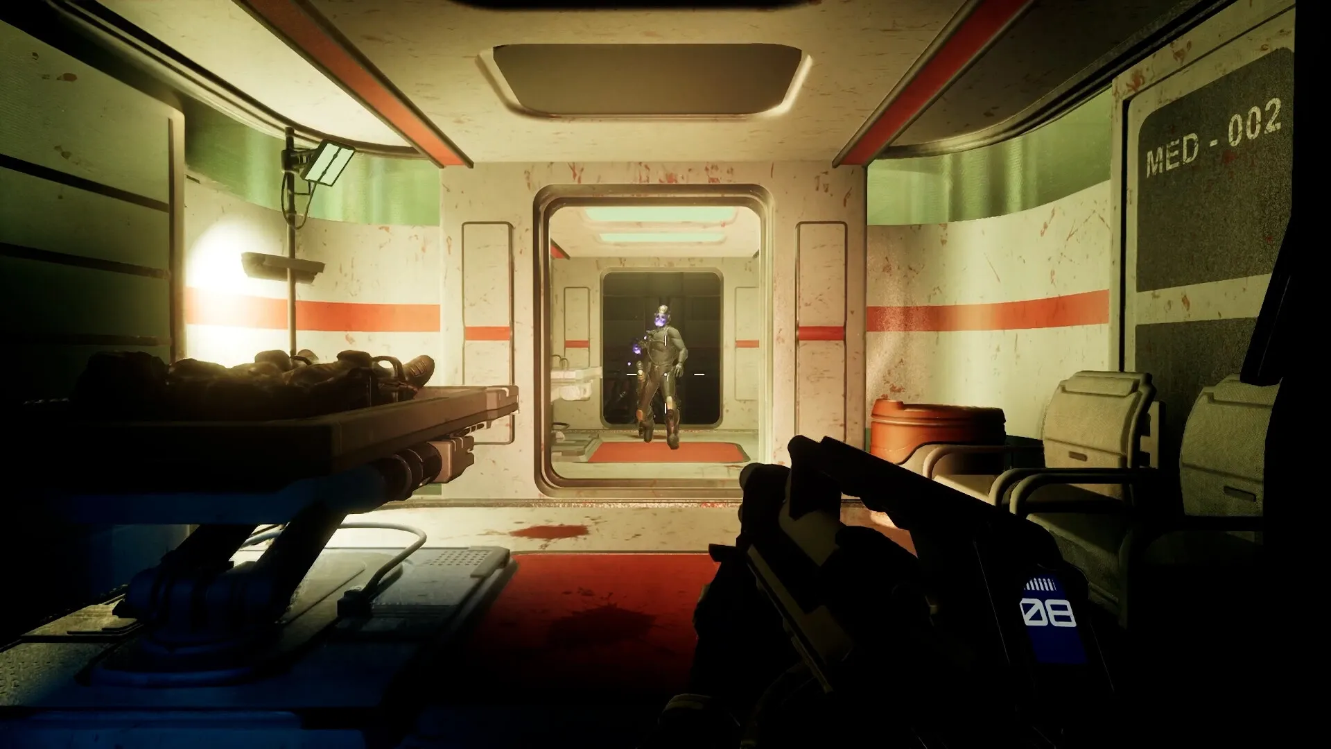 Deadzone: Player aiming at armored foe in dimly lit space corridor with medical room features
