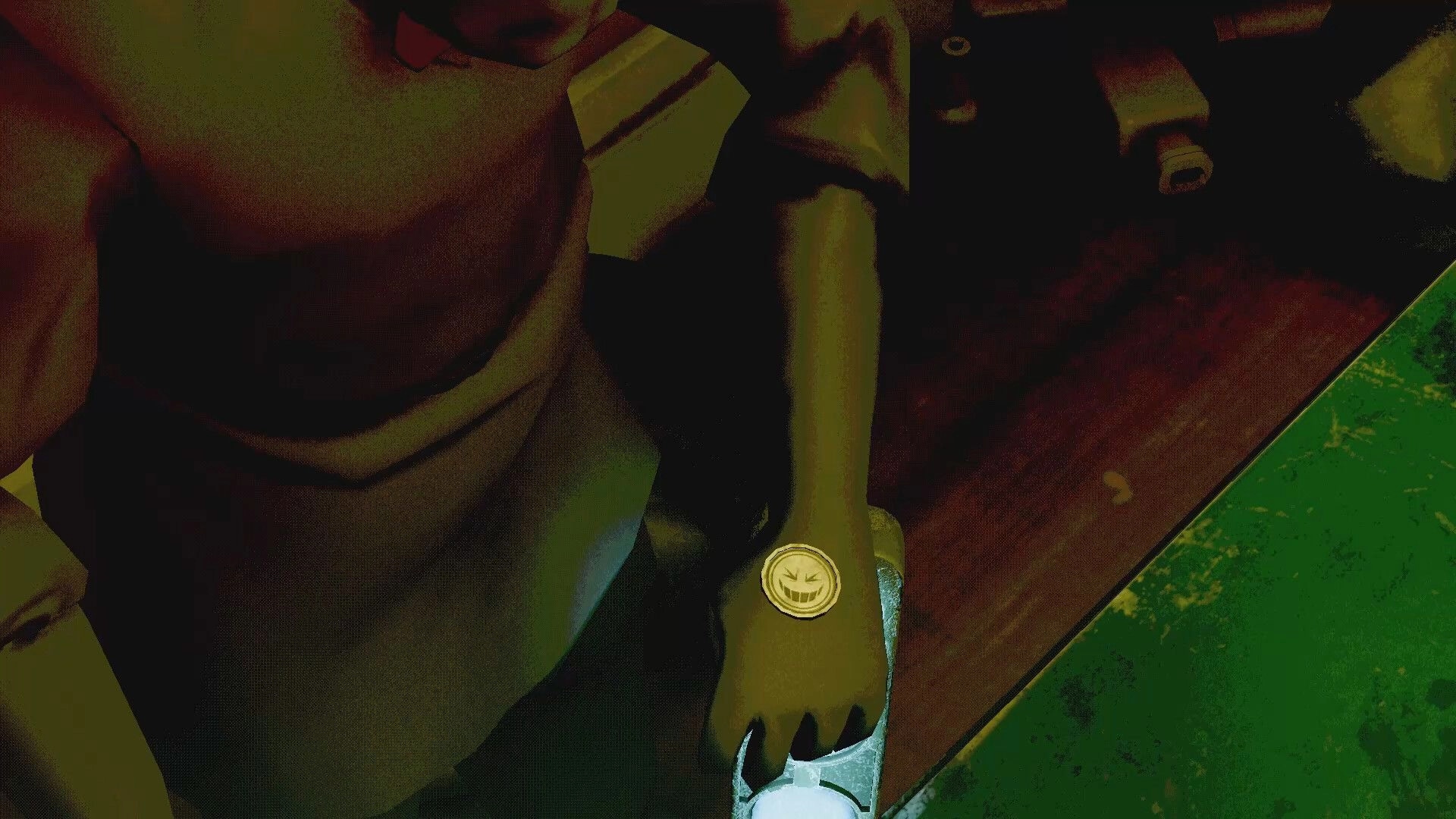 Death Pong: Close-up of player hand with smiley wrist icon beside a worn green table edge indoors.