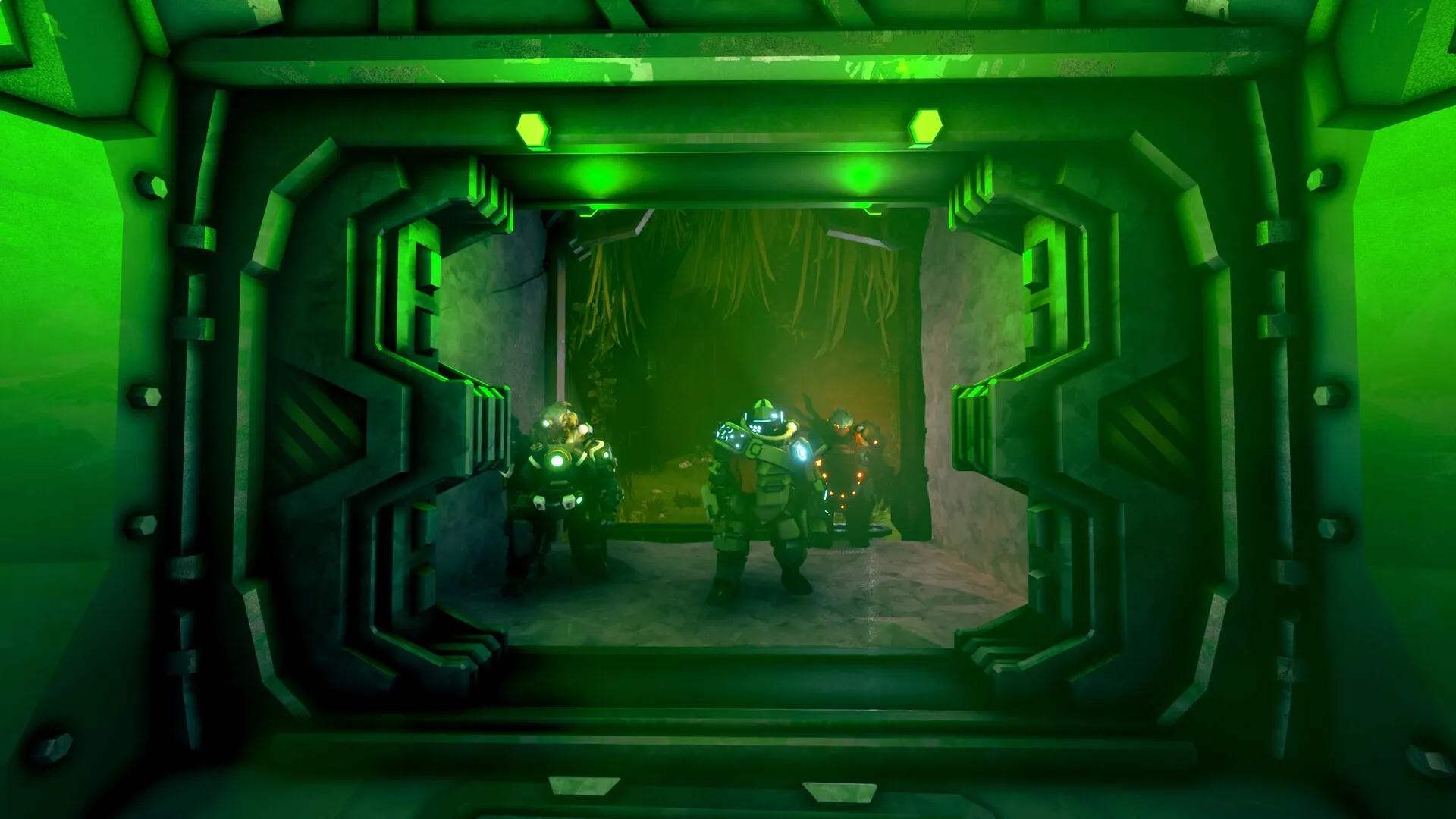 Deep Rock Galactic: Three dwarves in armored suits standing in a green-lit cave entrance