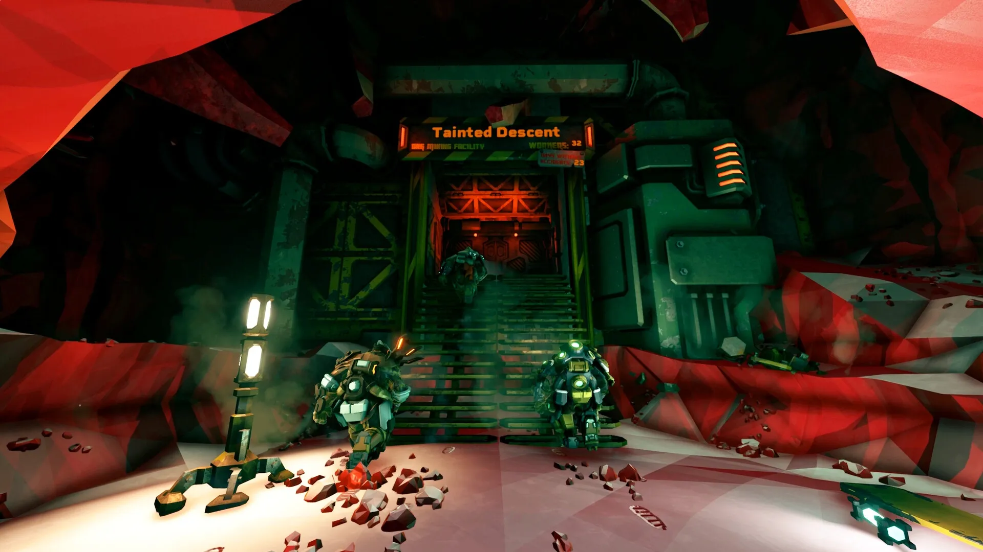 Deep Rock Galactic: Three dwarves approach a cave entrance labeled "Tainted Descent" in a mining facility