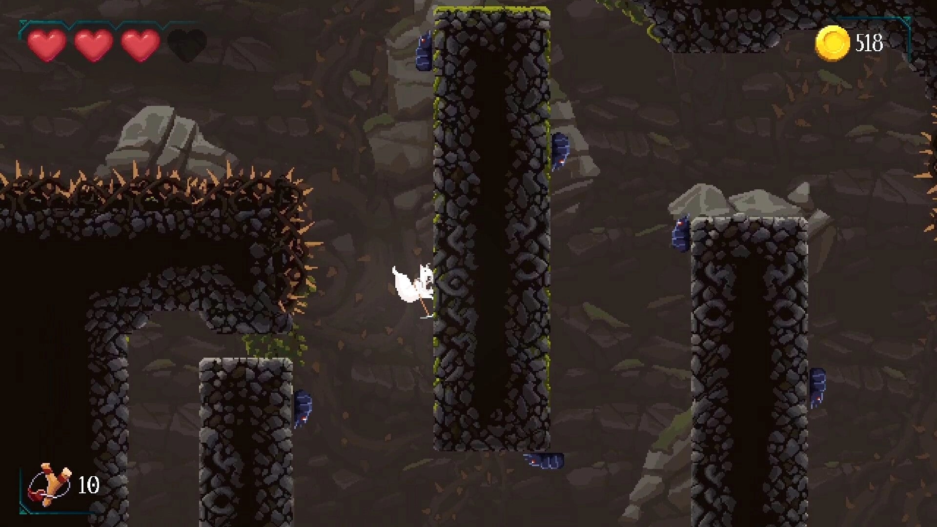 Demidoff Corp: White-cloaked hero wall-jumps between stone shafts with spikes, hearts and 518 coins UI.