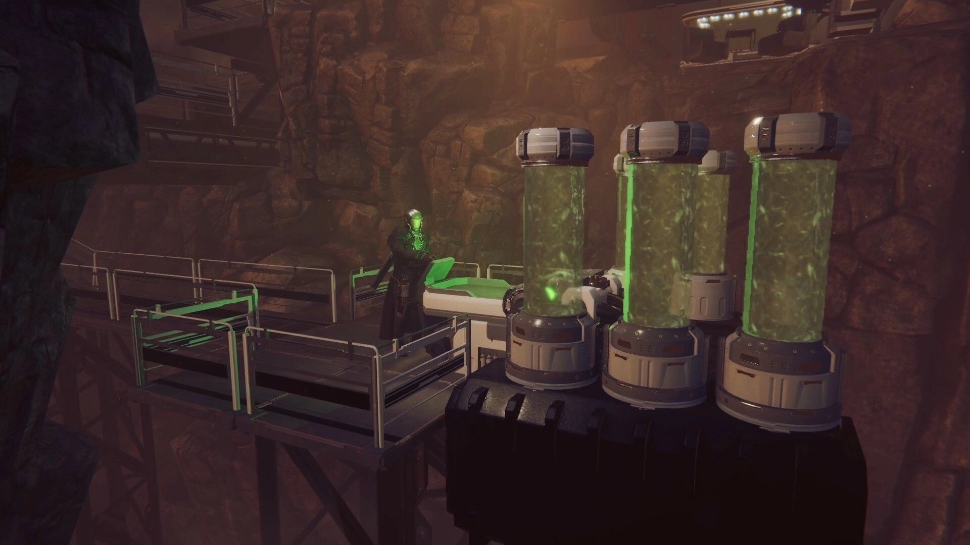 Drake Frontier: Character in futuristic armor examines glowing green tanks on elevated platform in canyon