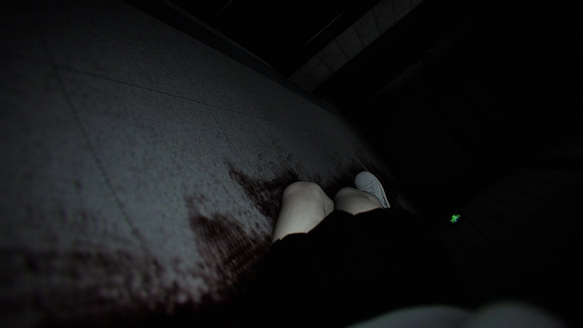 Dread Neighbor: Player crouches beside a bloodstained wall in a dark stairwell with a green HUD icon.