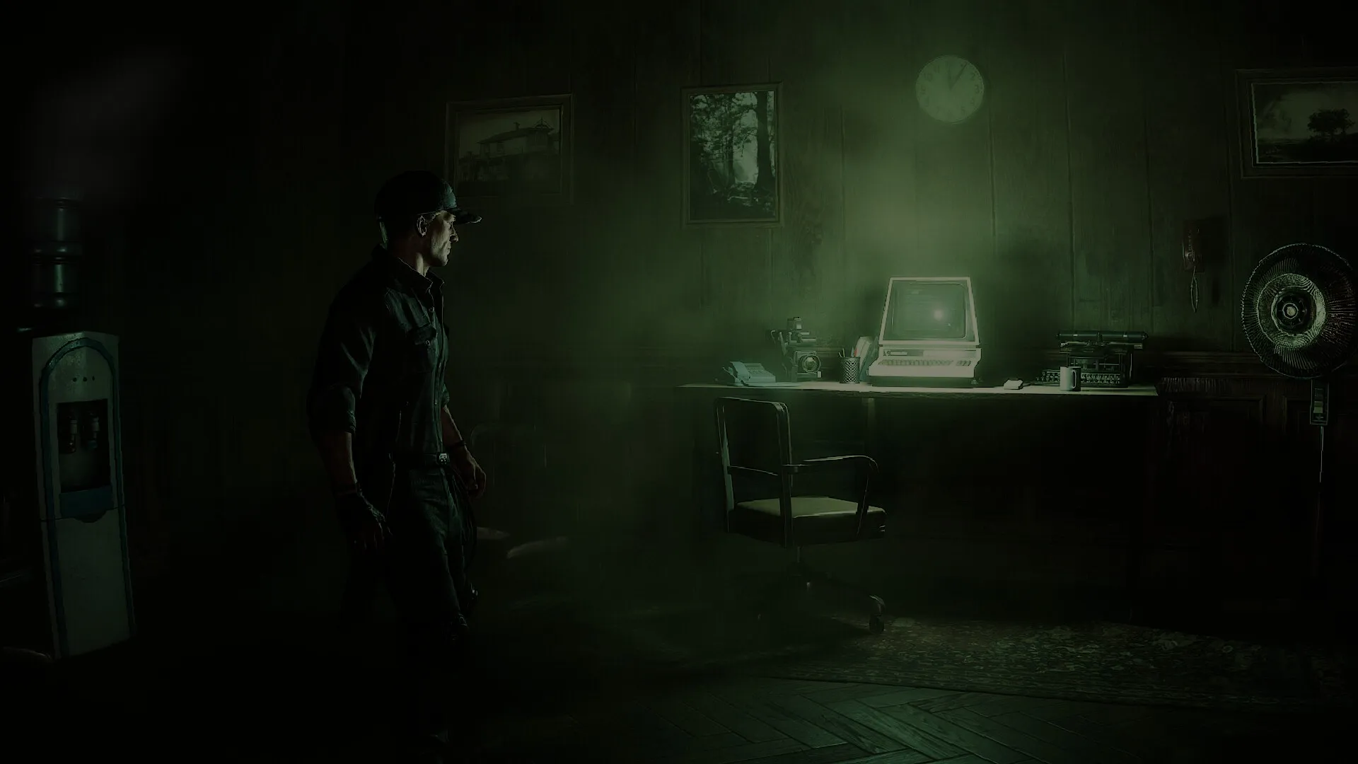 Dream Eaters.exe: Character in dark office, approaching glowing computer on desk, eerie atmosphere present.