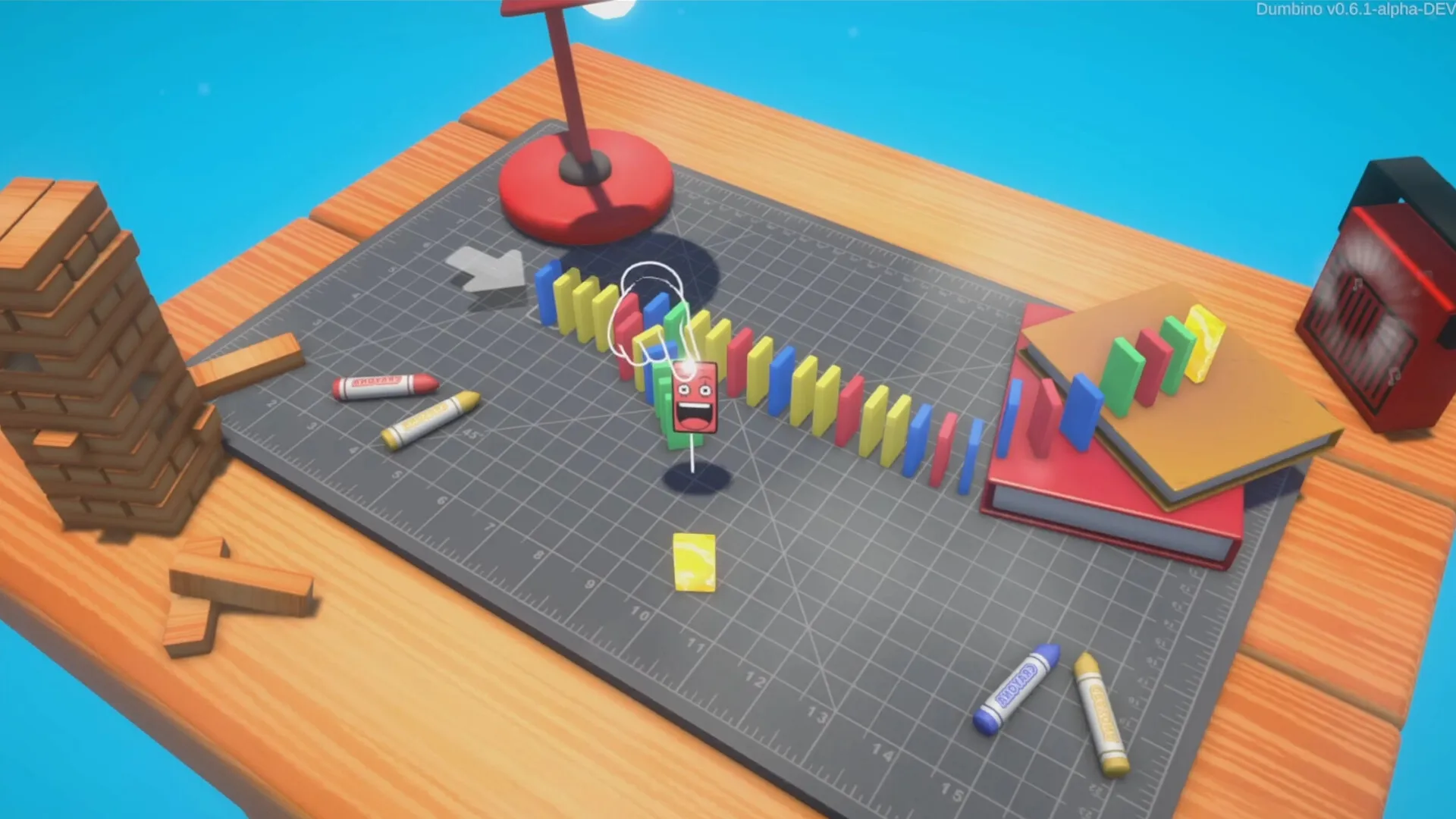 Dumbino: Colorful domino chain on a desk mat with crayons and a small red lamp nearby