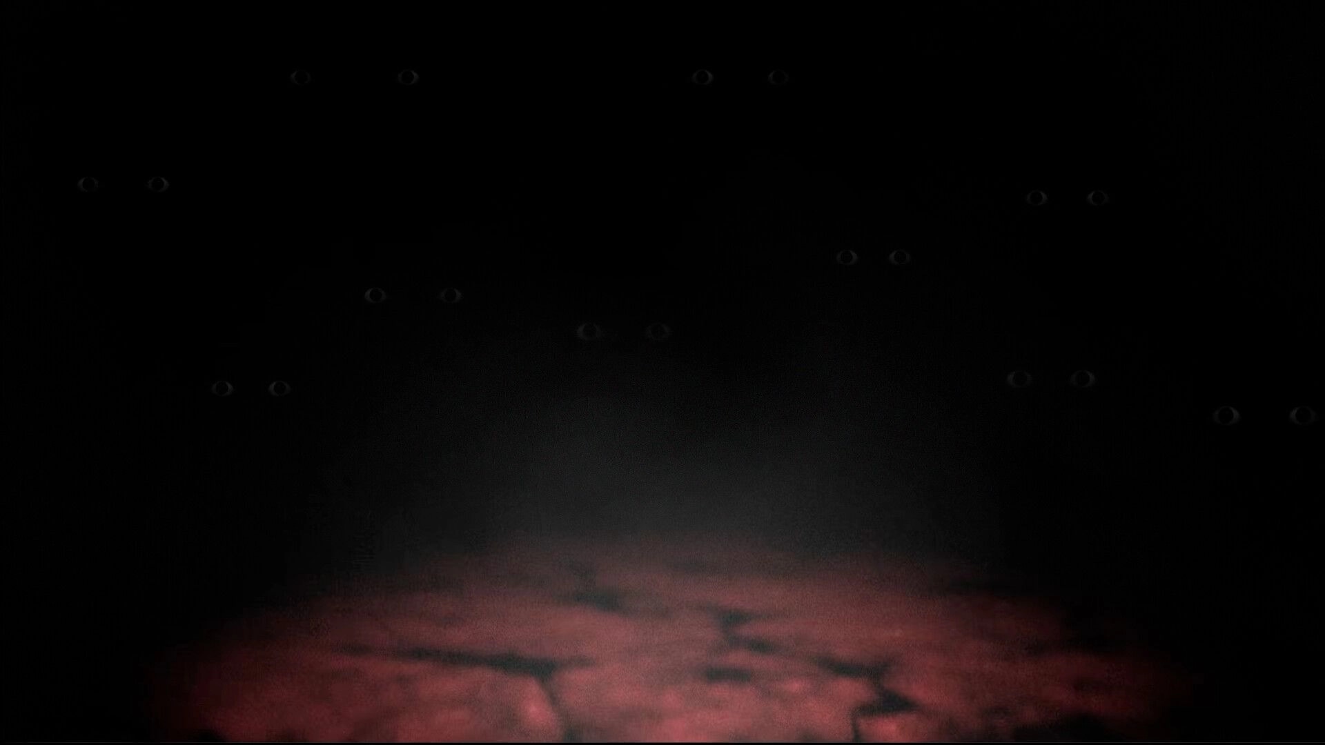 DUMMY HOUSE: Dim glowing eyes stare in pitch-black corridor above a faint red-lit floor path.
