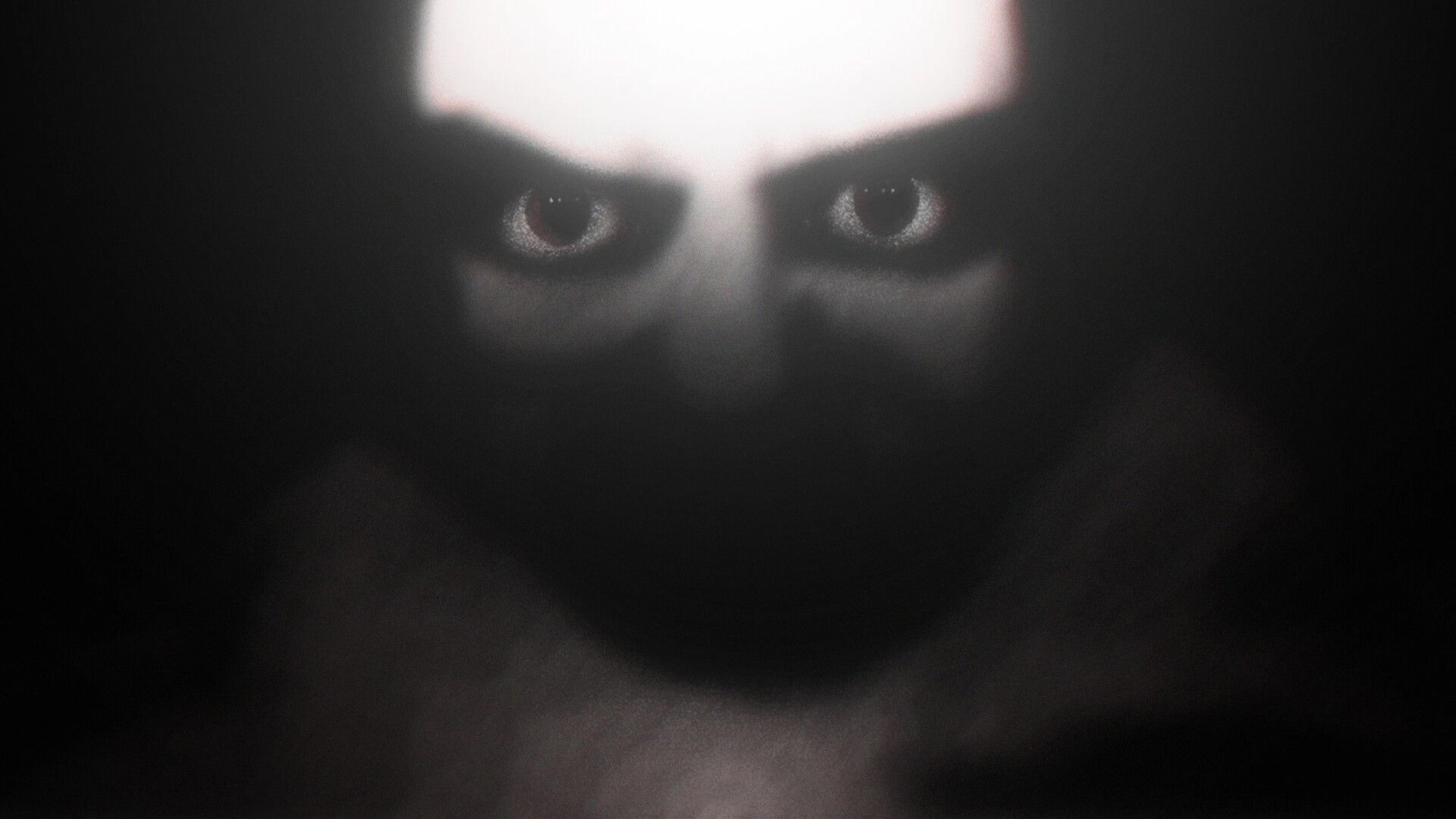 DUMMY HOUSE: Blurred close-up of a pale face with staring eyes emerging from deep darkness.