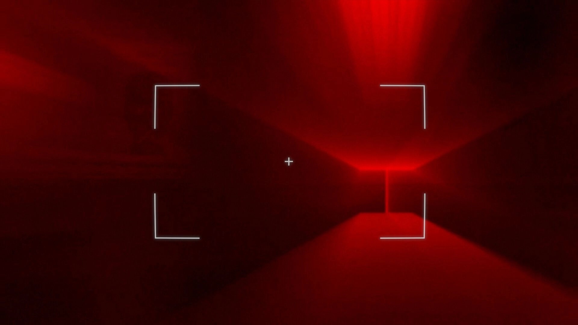DUMMY HOUSE: Camera viewfinder crosshair aimed down a red-lit industrial corridor in darkness.
