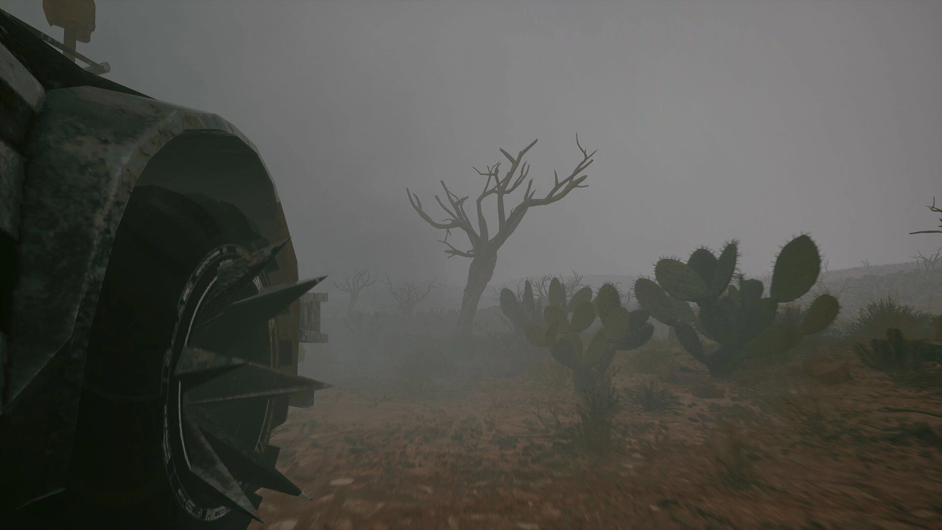 Duneborn: Spiked war vehicle wheel traversing foggy desert with cacti and barren trees in the background