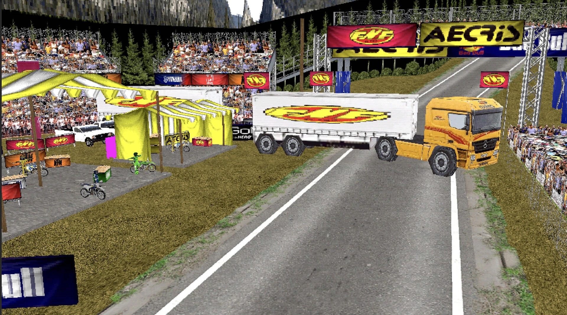 DüRT: Semi truck and trailer blocking track near pit tents and grandstands under sponsor banners.