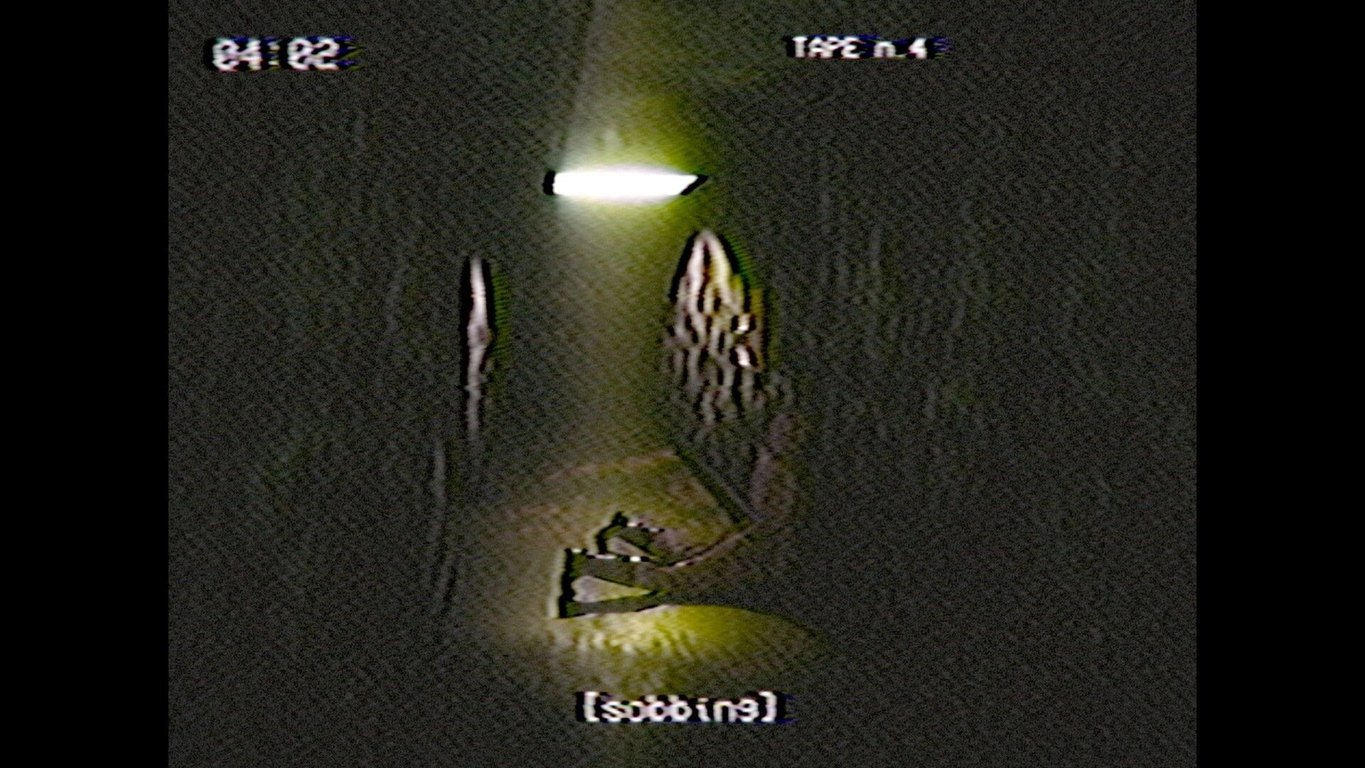 ENTRY_13: VHS HUD with timecode and TAPE n.4 over a dim hallway with debris under a light.