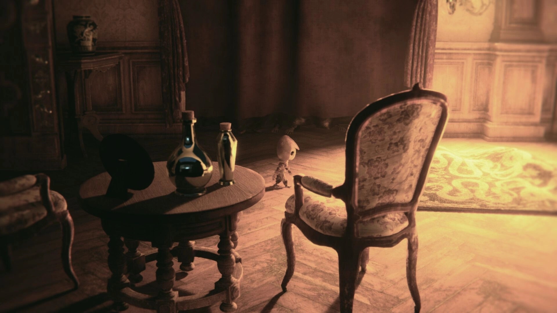 EONA: Tiny doll-like character walks past a table with bottles and chairs in a dim parlor room.