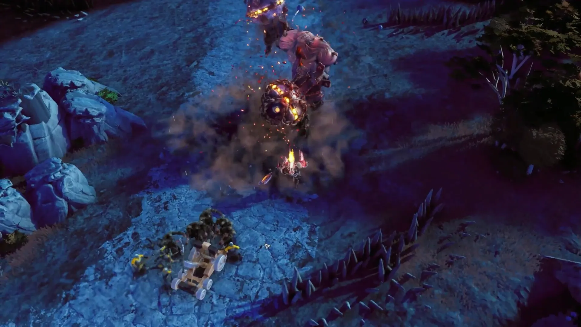 EverSiege: Giant enemy attacks as player crew maneuvers siege weapon in rocky terrain at night.