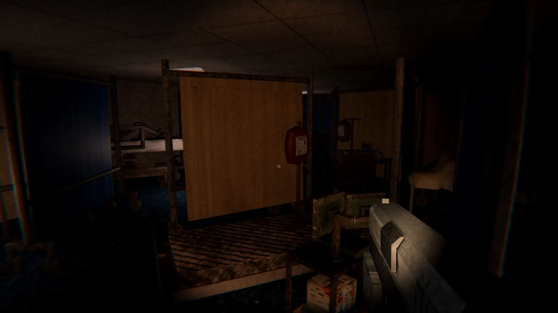 Evil Lurks Below: Harry Walters explores dimly lit room with makeshift partitions in the Gilman house.