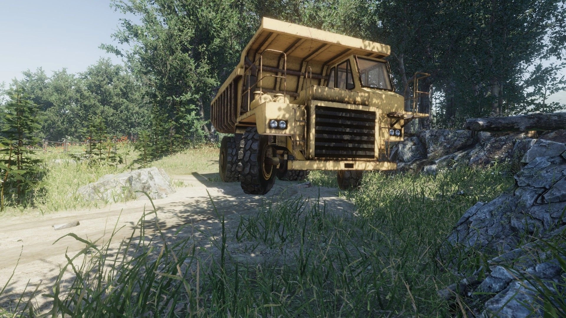 eXpanSIM: Large yellow dump truck navigating a rugged forest path surrounded by dense greenery