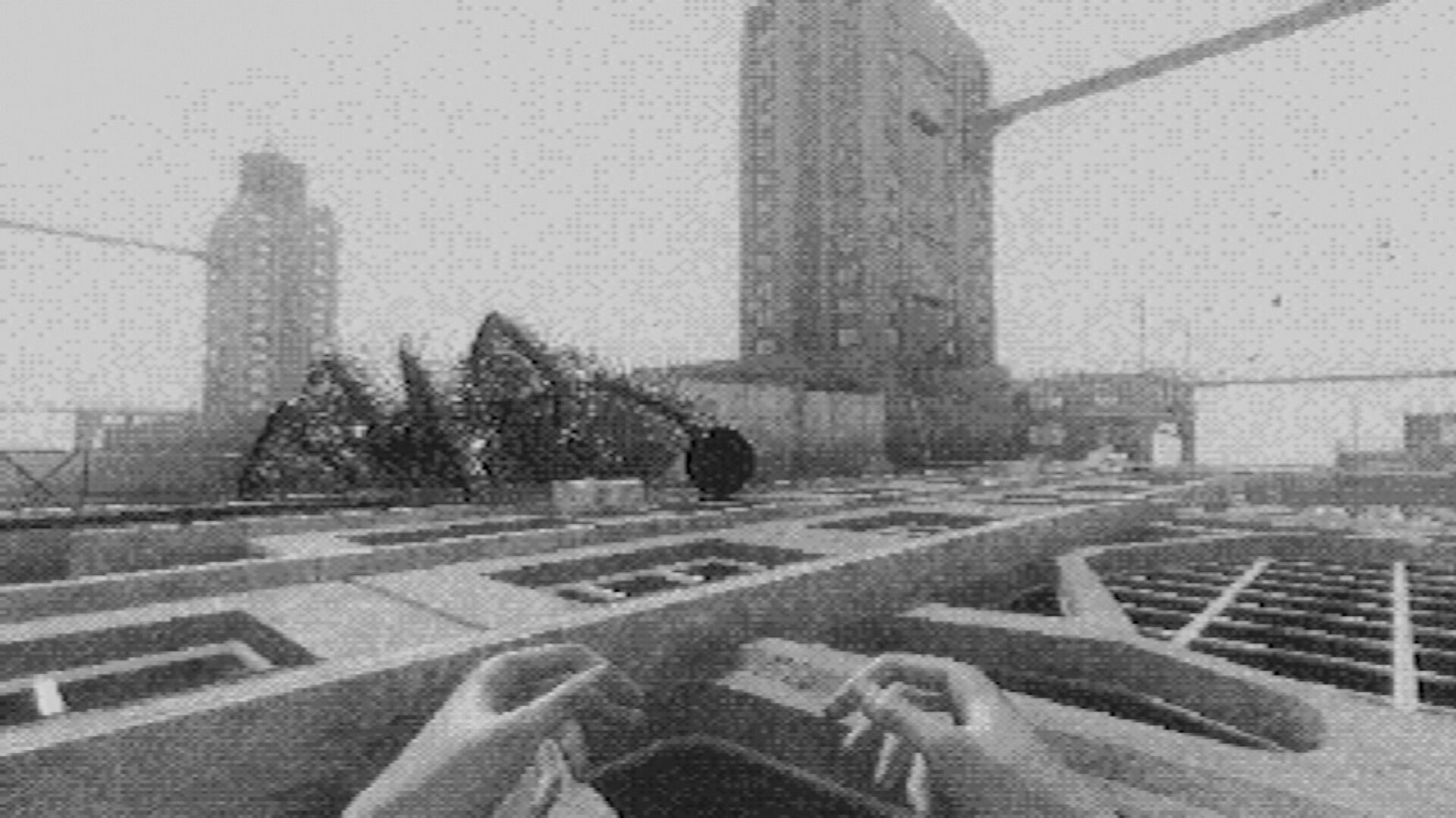 Fallgrade: First-person view over rooftop grates toward rubble and tall concrete towers in haze.