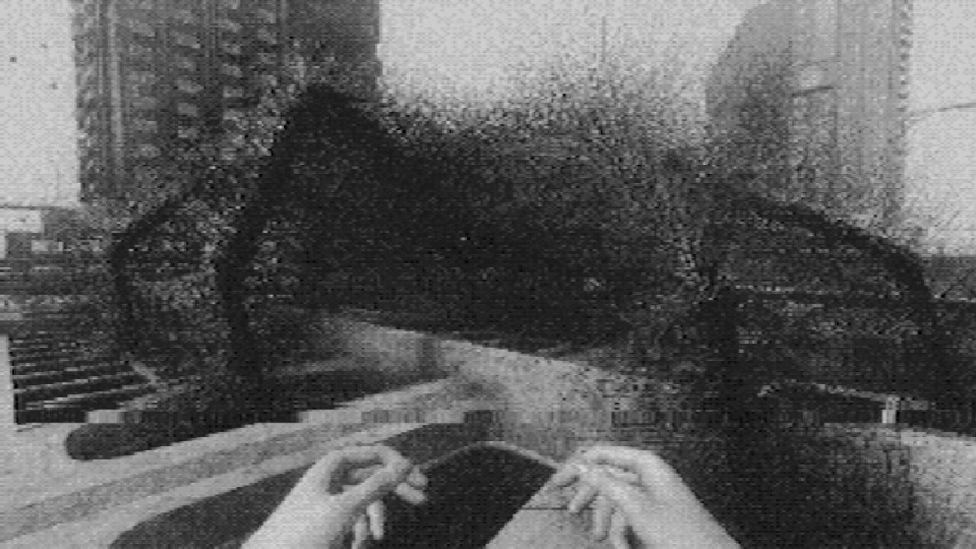 Fallgrade: First-person view of hands on a ledge facing a dark void in a grainy concrete room.